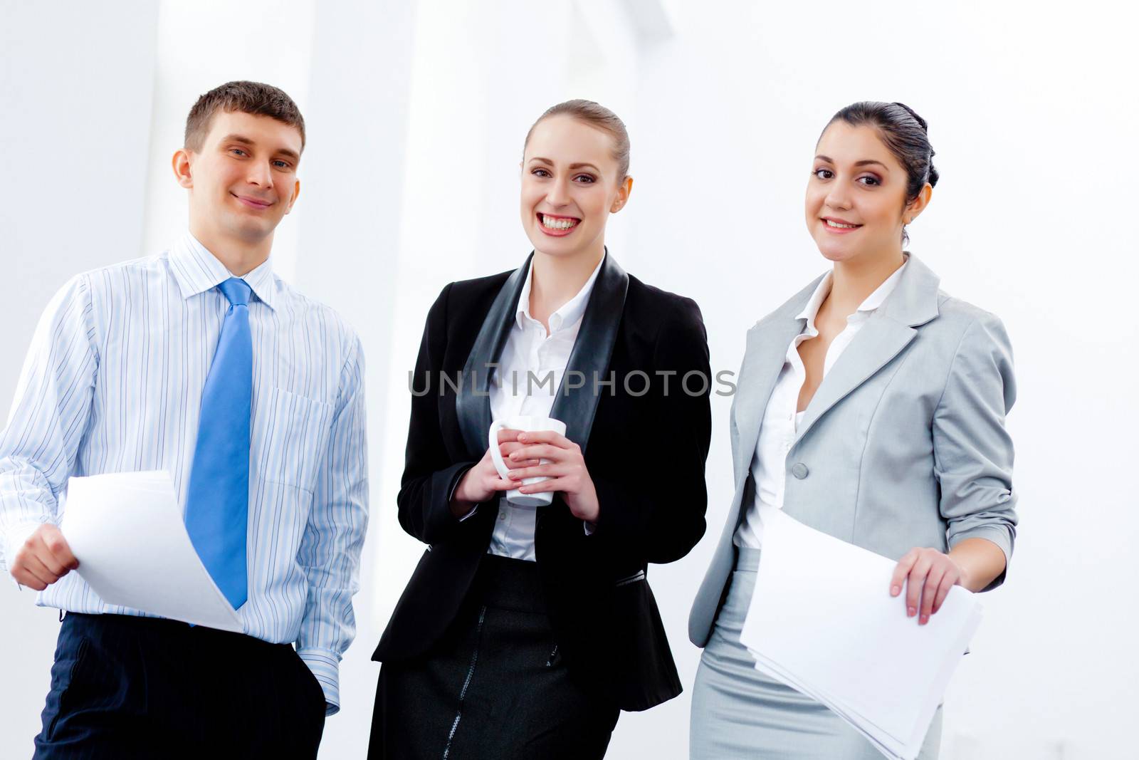 Three young business people laughing by sergey_nivens
