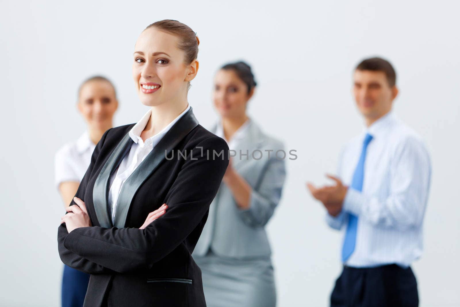 Image of four pretty young businesswomen standing in row