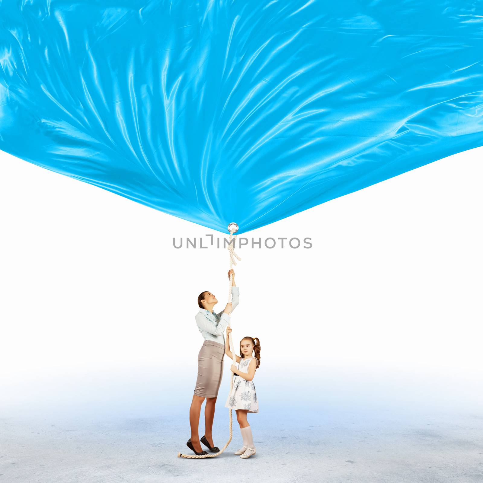 Image of young happy family pulling blank banner