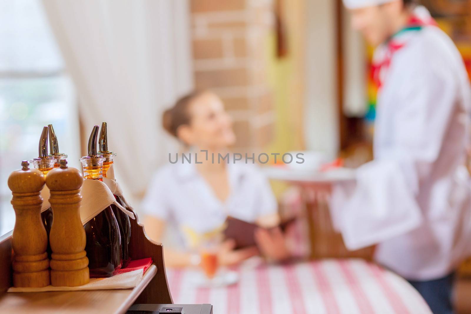 Young woman at restaurant sitting at table