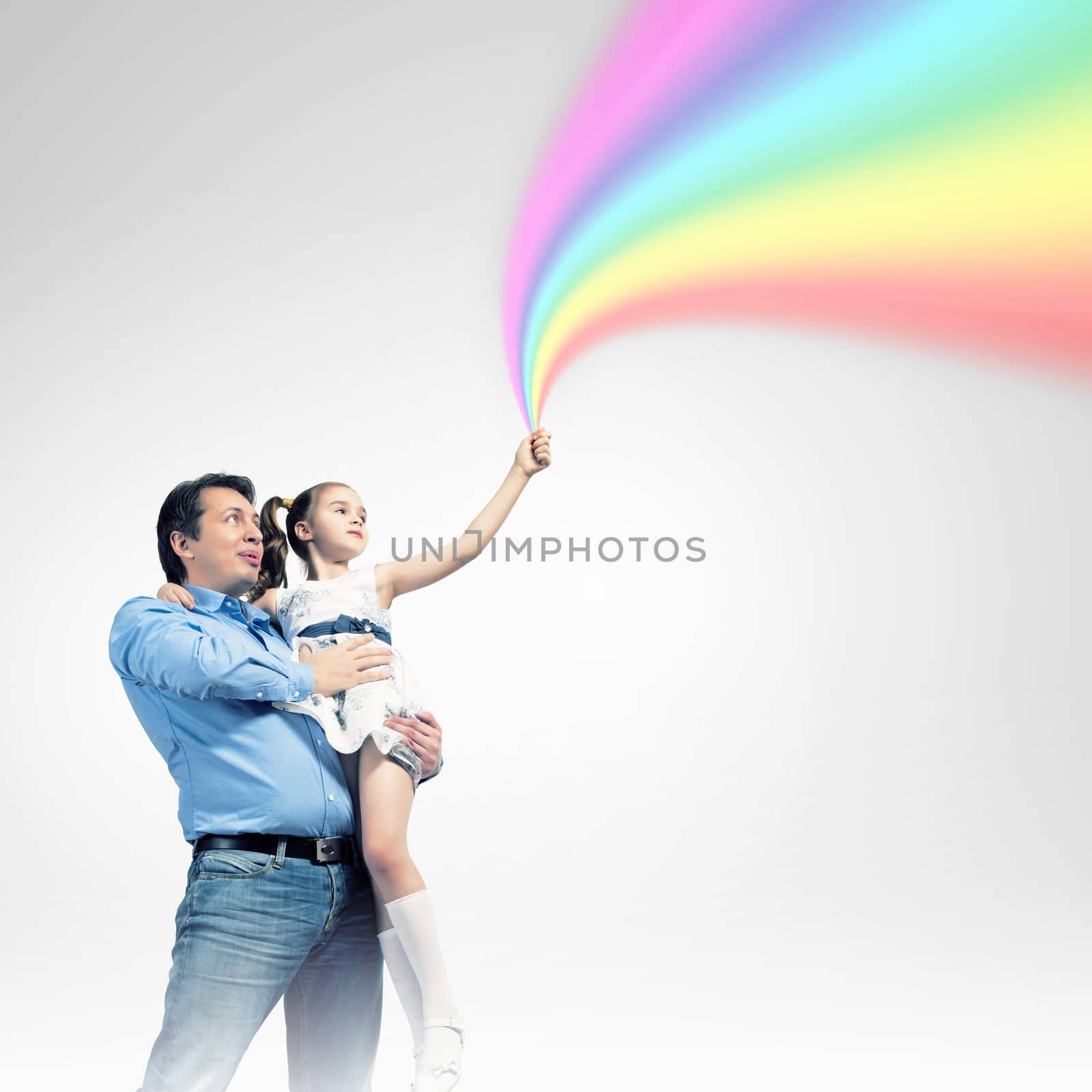 Image of happy father holding on hands daughter ad rainbow