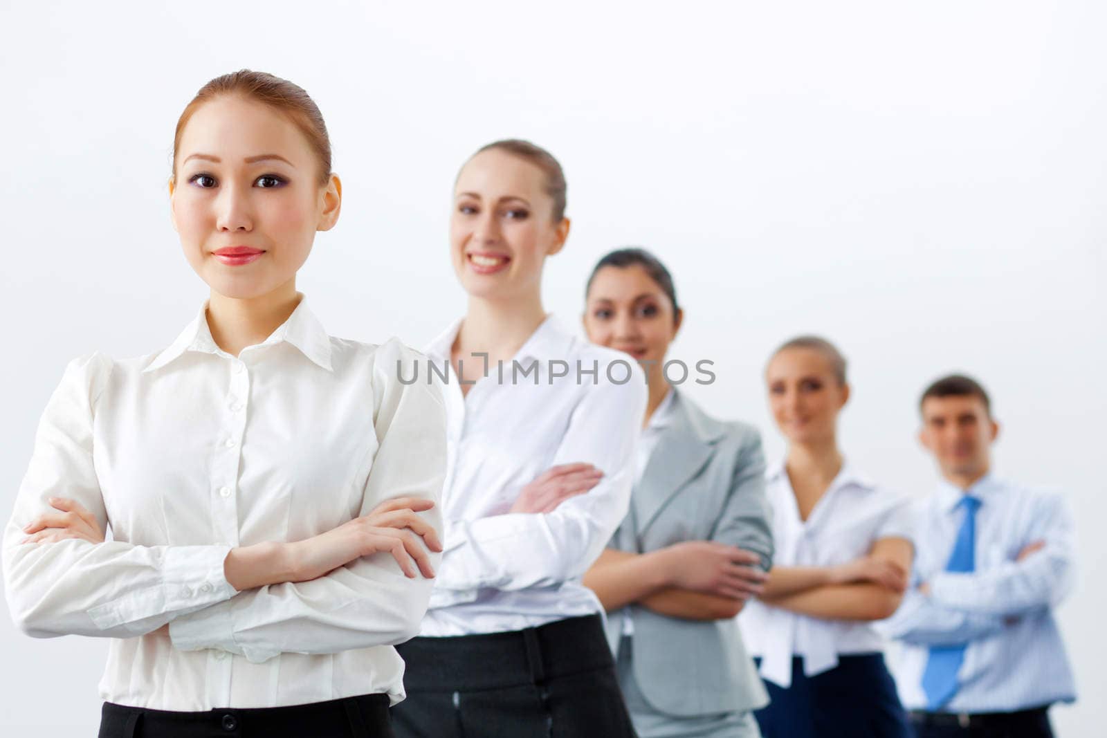 Group of businesspeople smiling standing with arms crossed