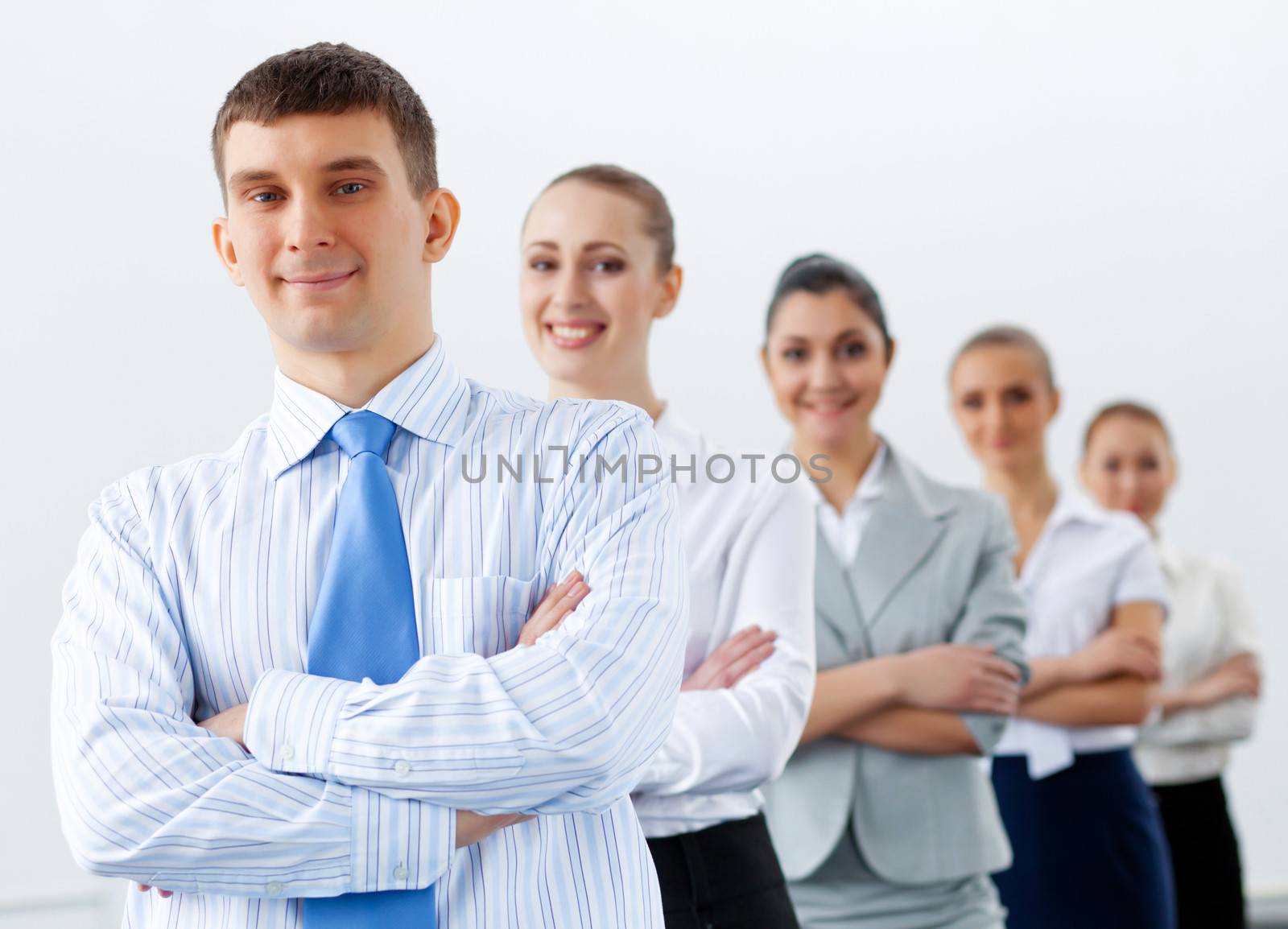 Group of businesspeople smiling standing with arms crossed