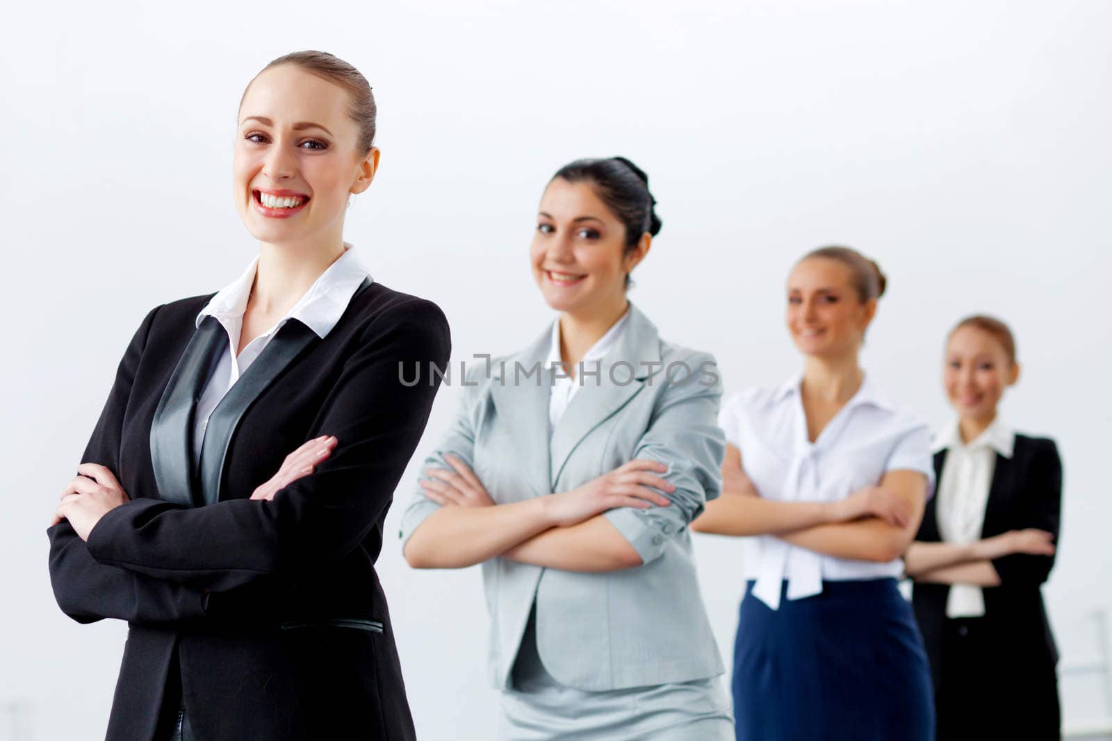 Four businesswomen standing in row by sergey_nivens
