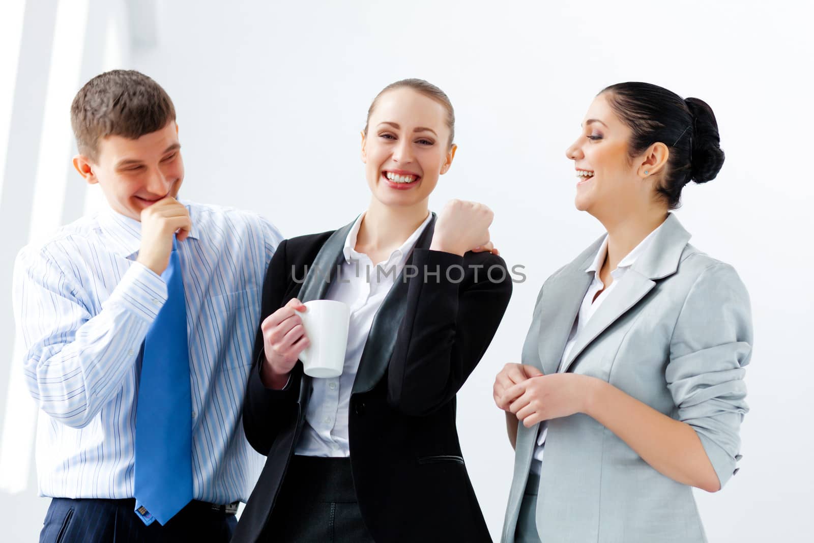 Three young business people laughing by sergey_nivens