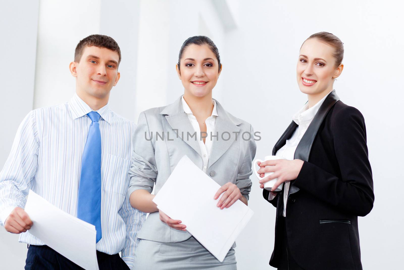 Image of three young businesspeople laughing joyfully