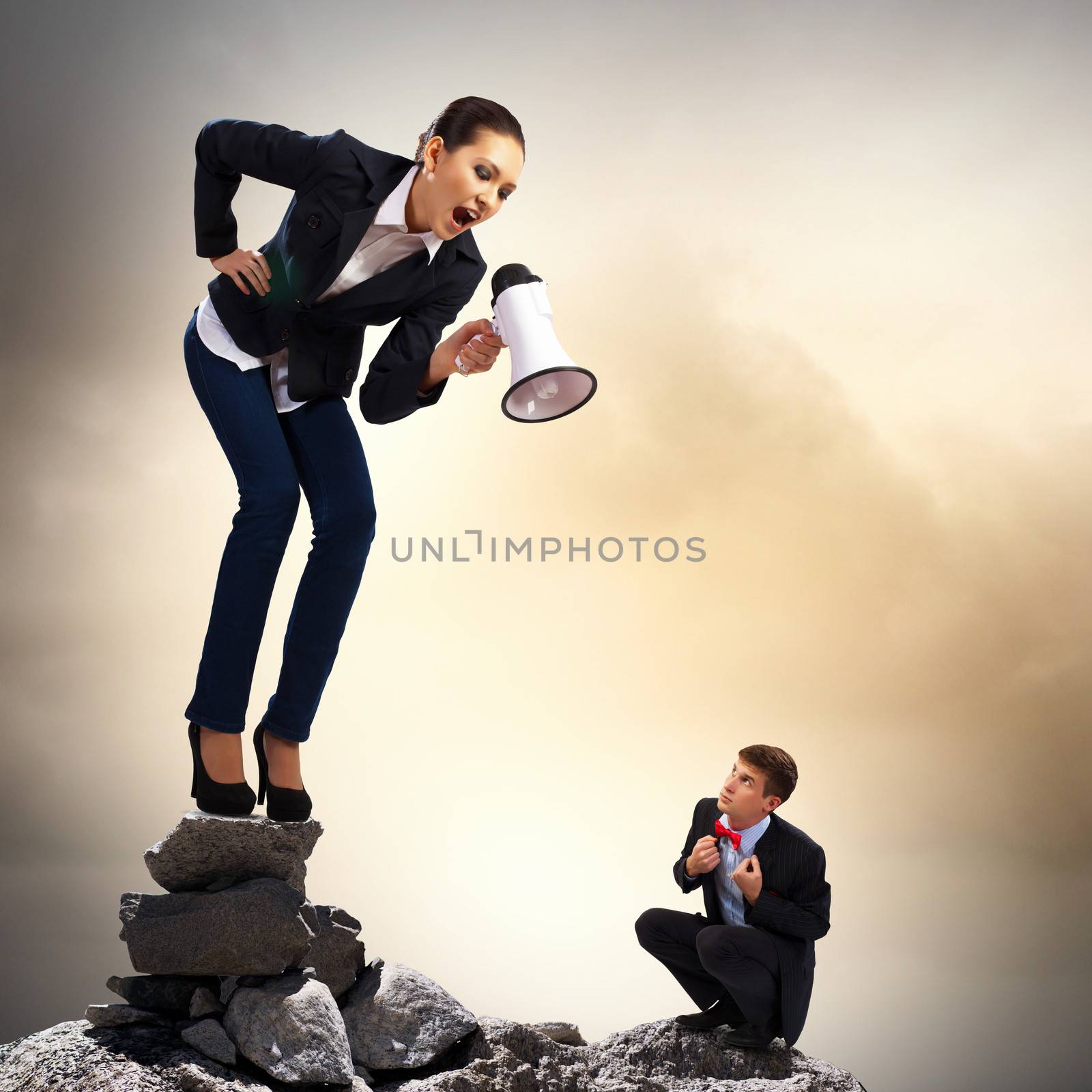 Angry businesswoman with megaphone shouting at colleague