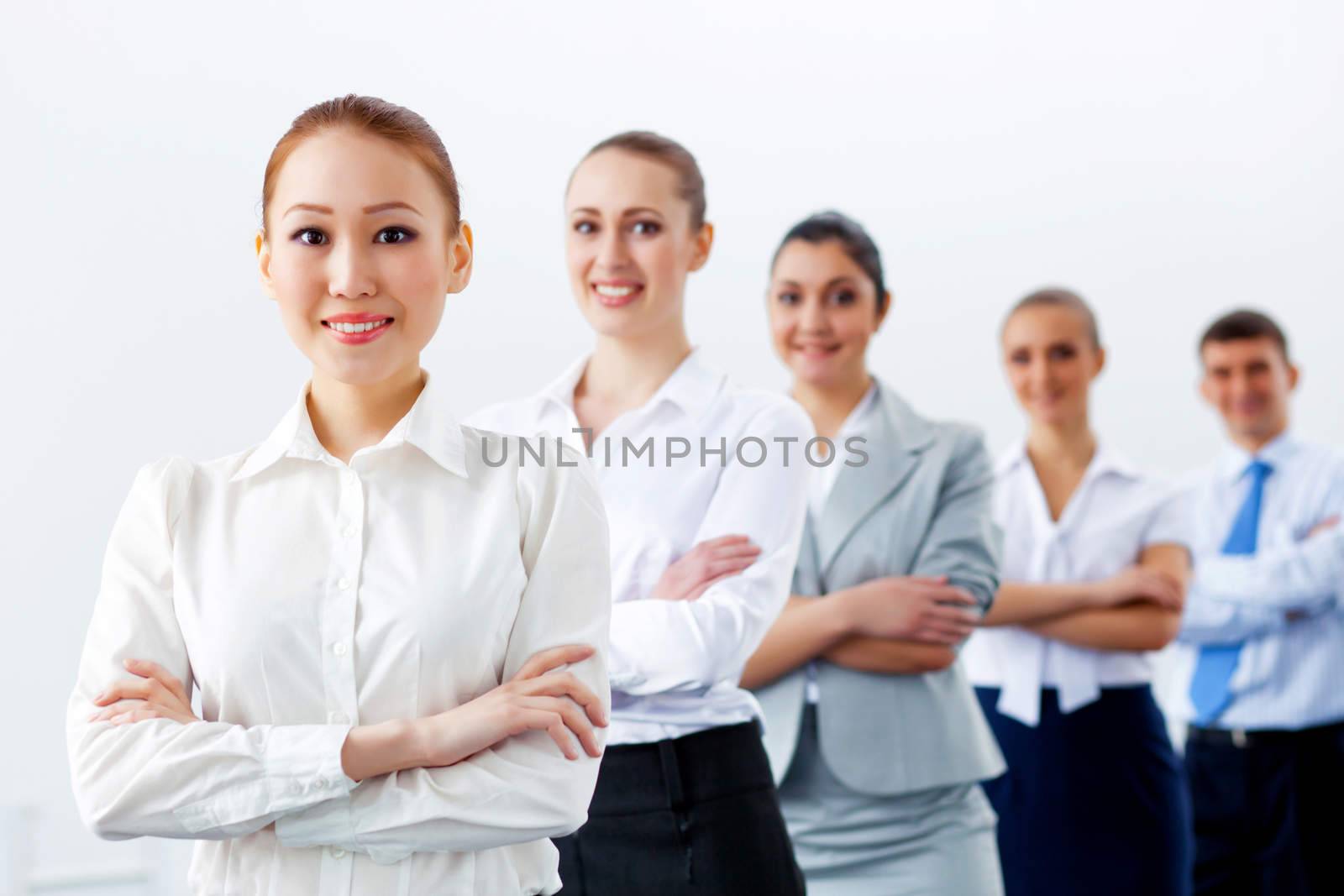 Group of businesspeople smiling standing with arms crossed