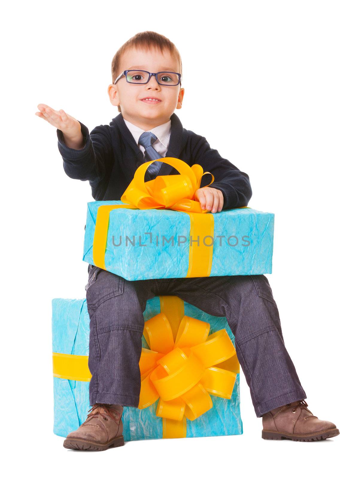 Small boy in spectecles with big present on white background
