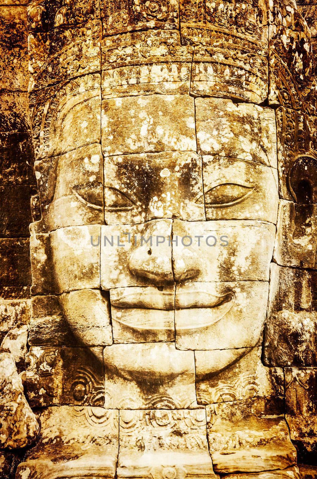 Detail of vintage stone face in the Bayon temple at Angkor Wat by martinm303