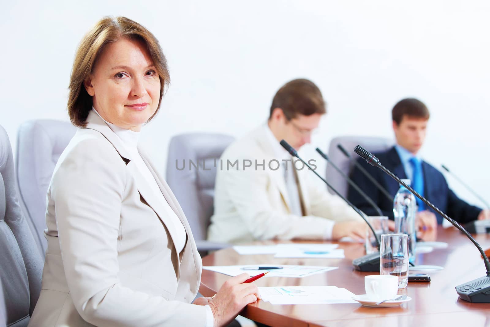 Three businesspeople at meeting by sergey_nivens