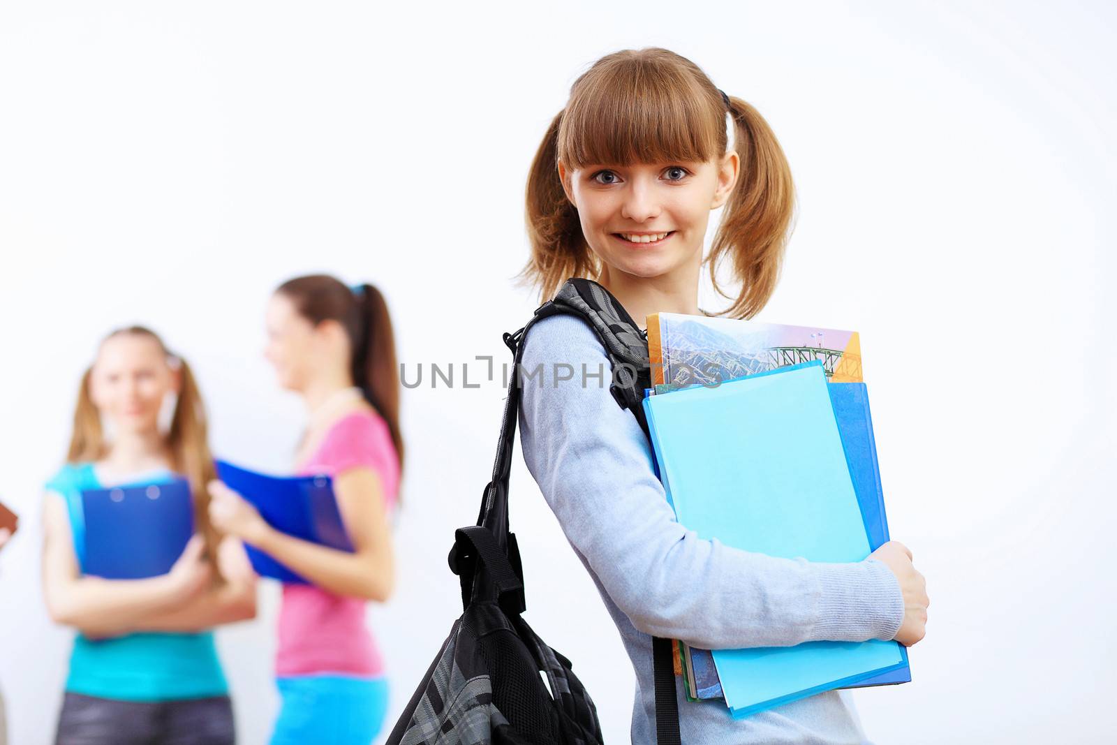 Young female student at college with books