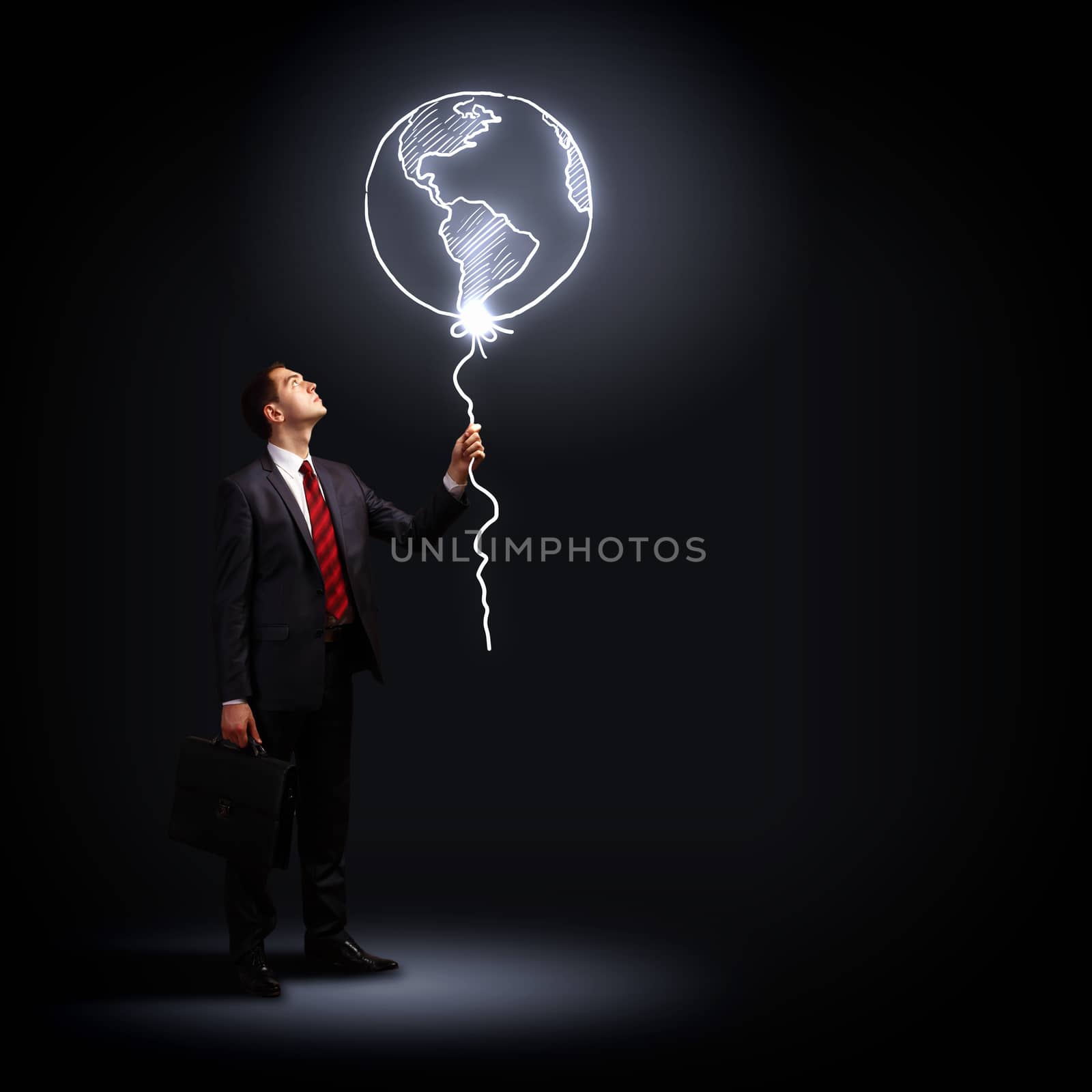 Image of businessman in black suit against dark background