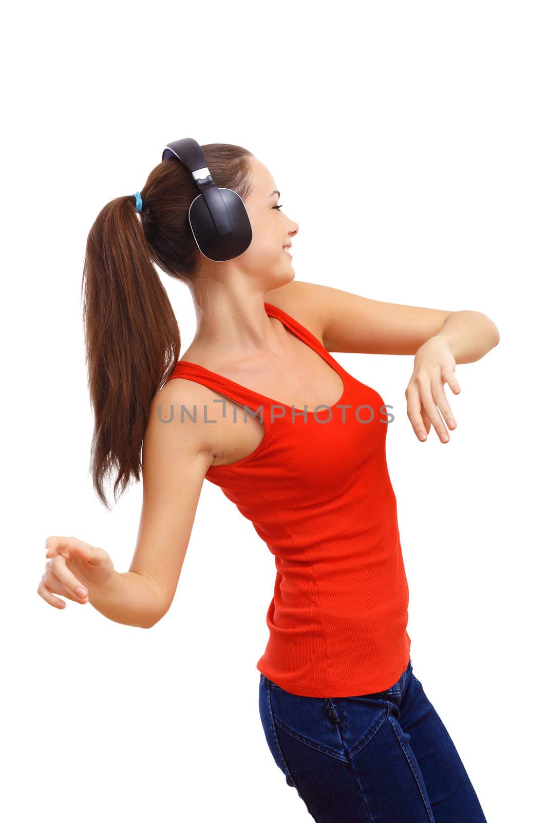 Happy smiling girl dancing and listening to music