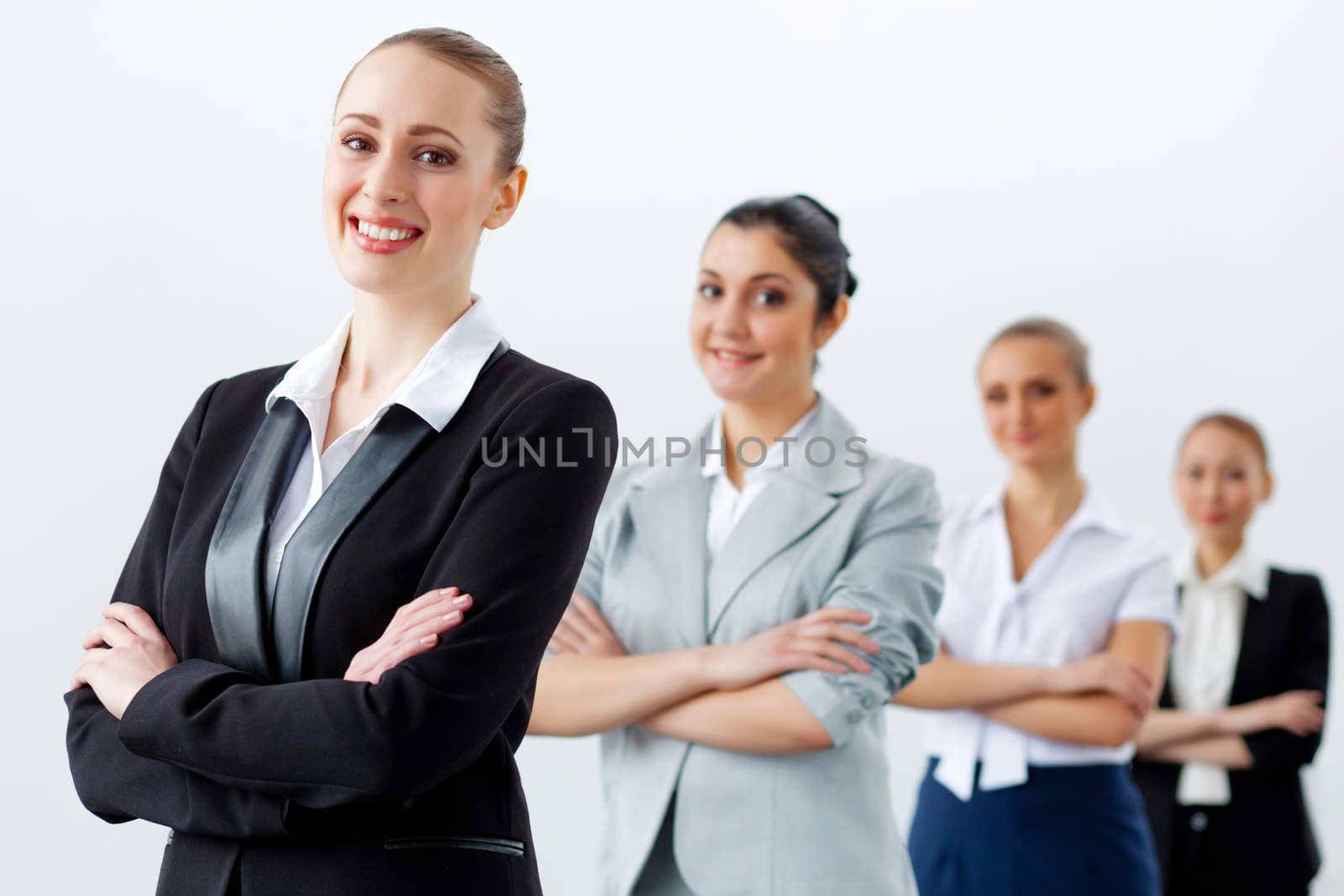 Image of three young businesspeople laughing joyfully