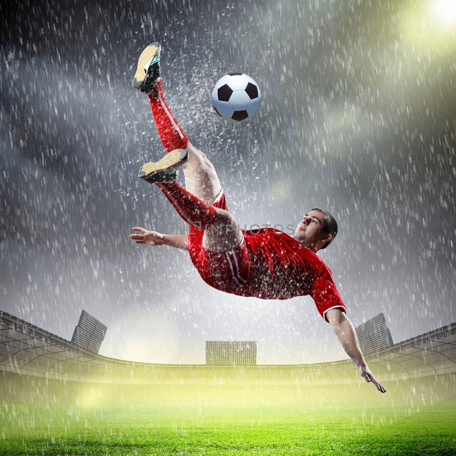 football player in red shirt striking the ball at the stadium under rain