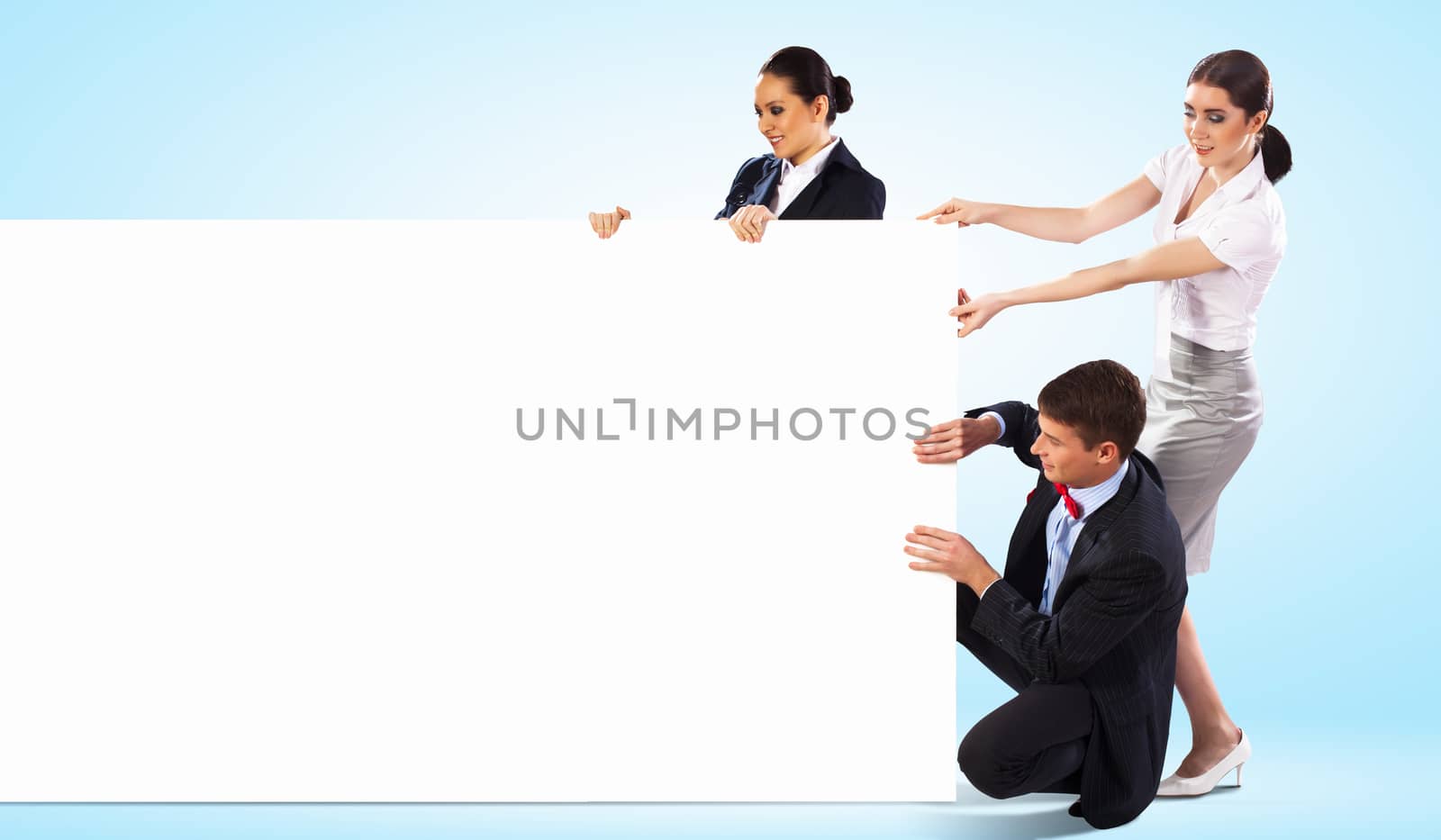 Image of three young people holding blank banner. Place for text