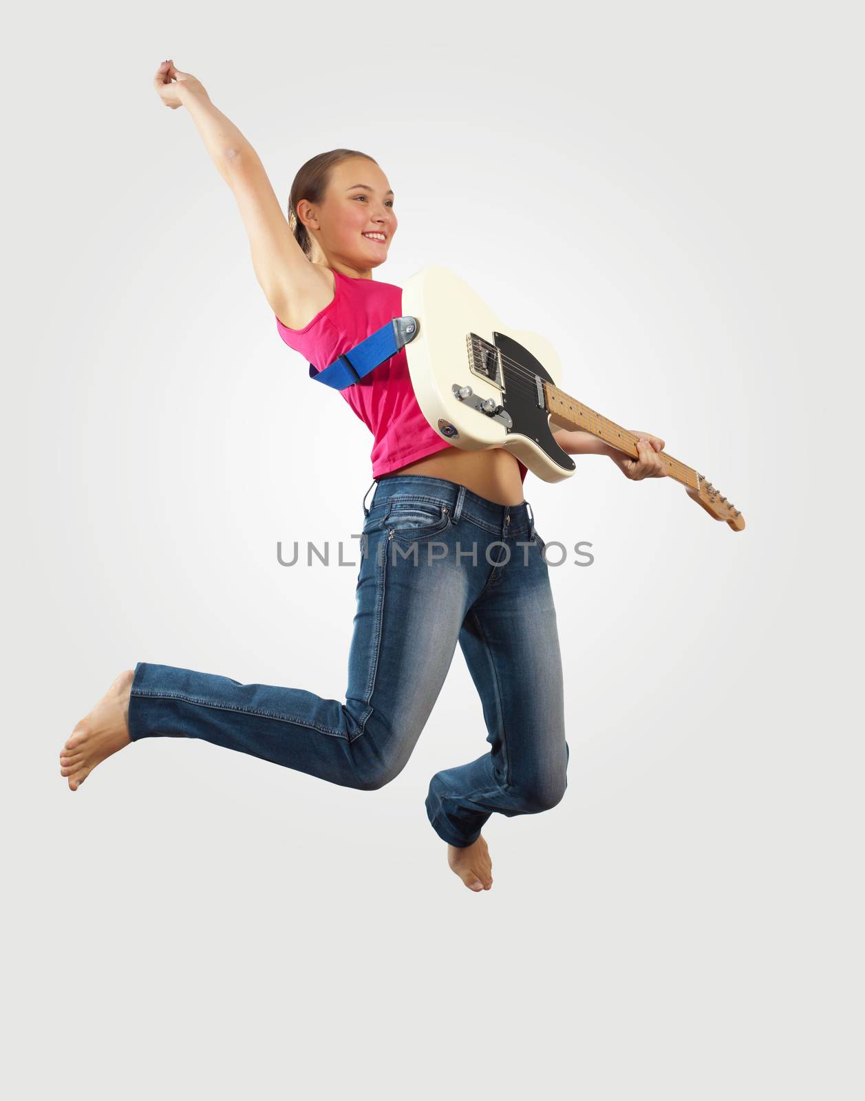 young woman playing on electro guitar and jumping