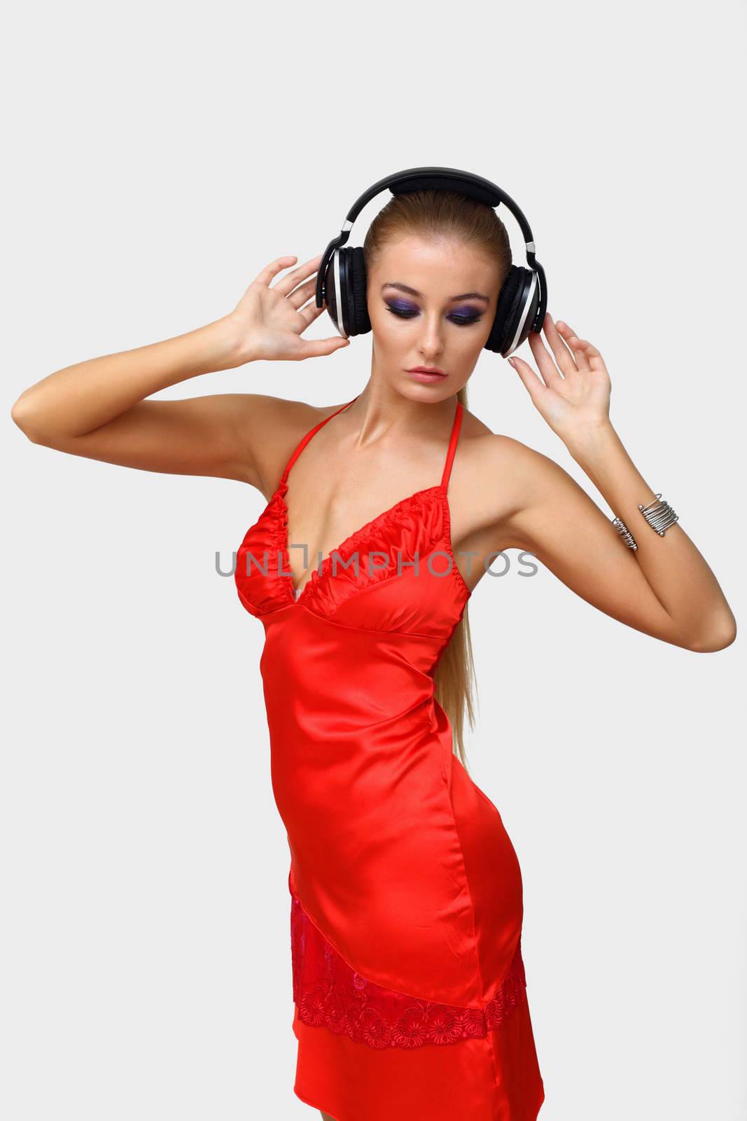 Portrait of young woman with headphones in studio