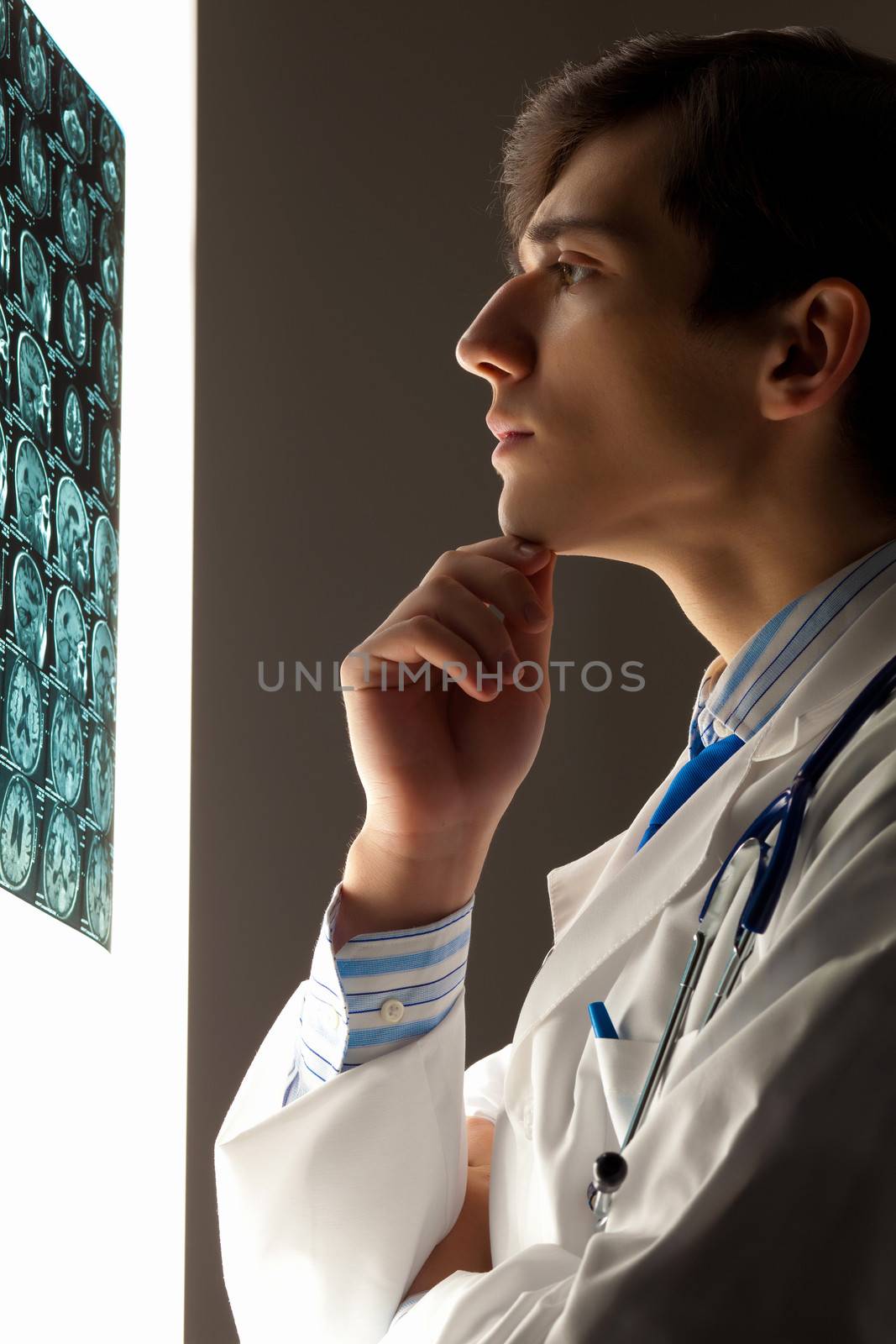 Man doctor looking at x-ray by sergey_nivens