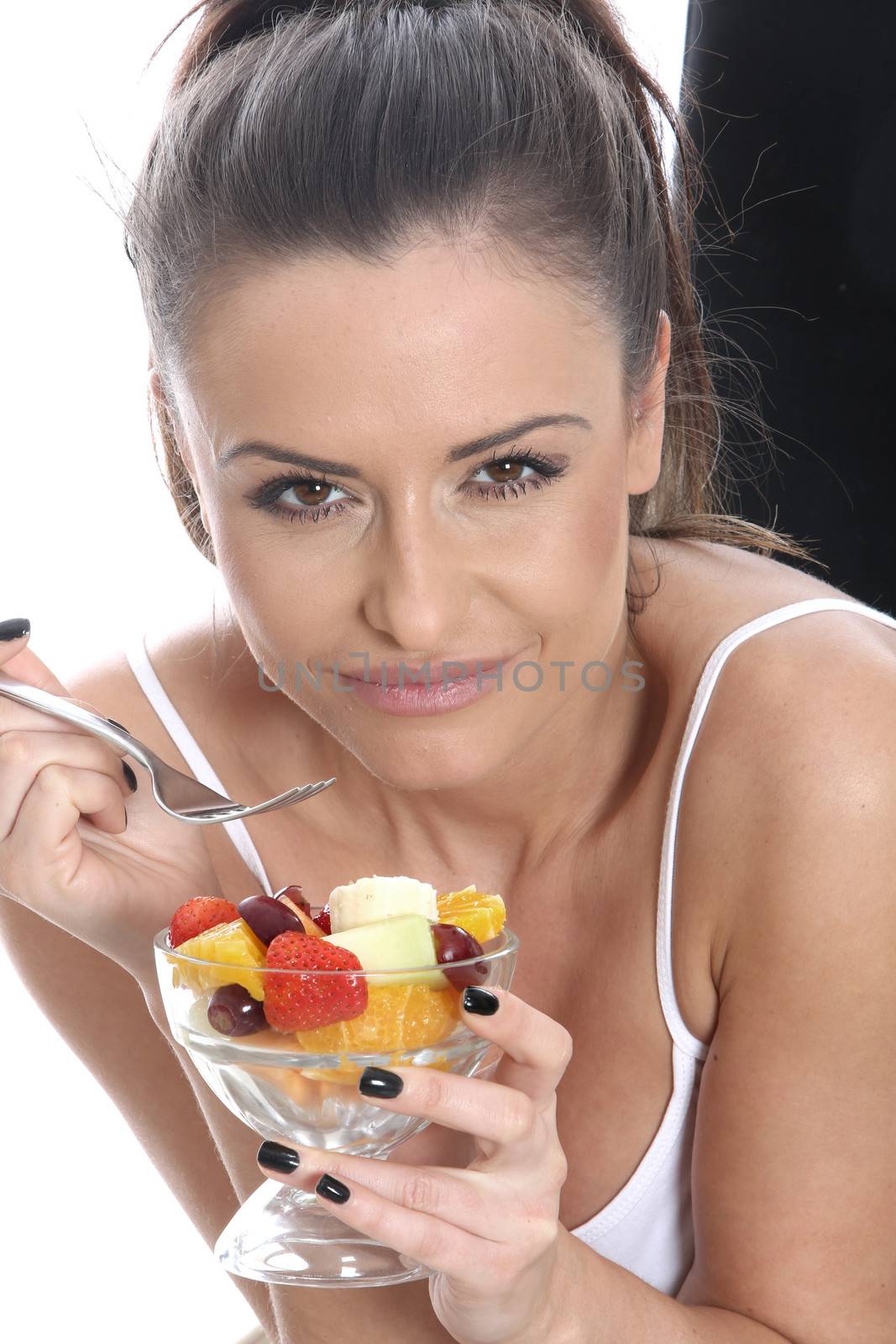 Model Released. Young Woman Eating Fresh Fruit Salad