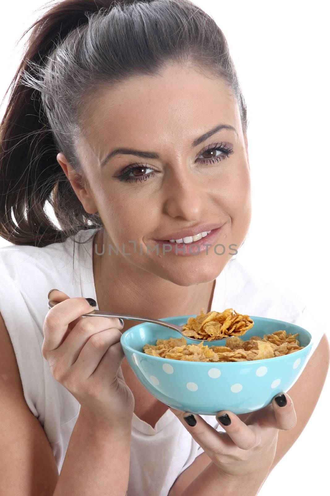 Model Released. Young Woman Eating a Bowl of Breakfast Cereal