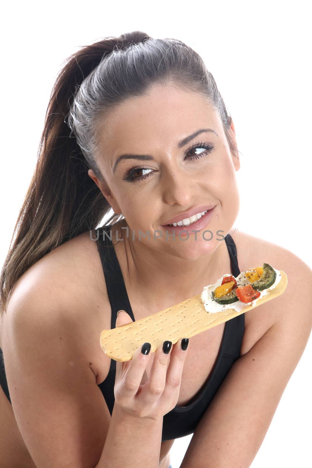 Model Released. Young woman Eating Flatbread with Roast Vegetables