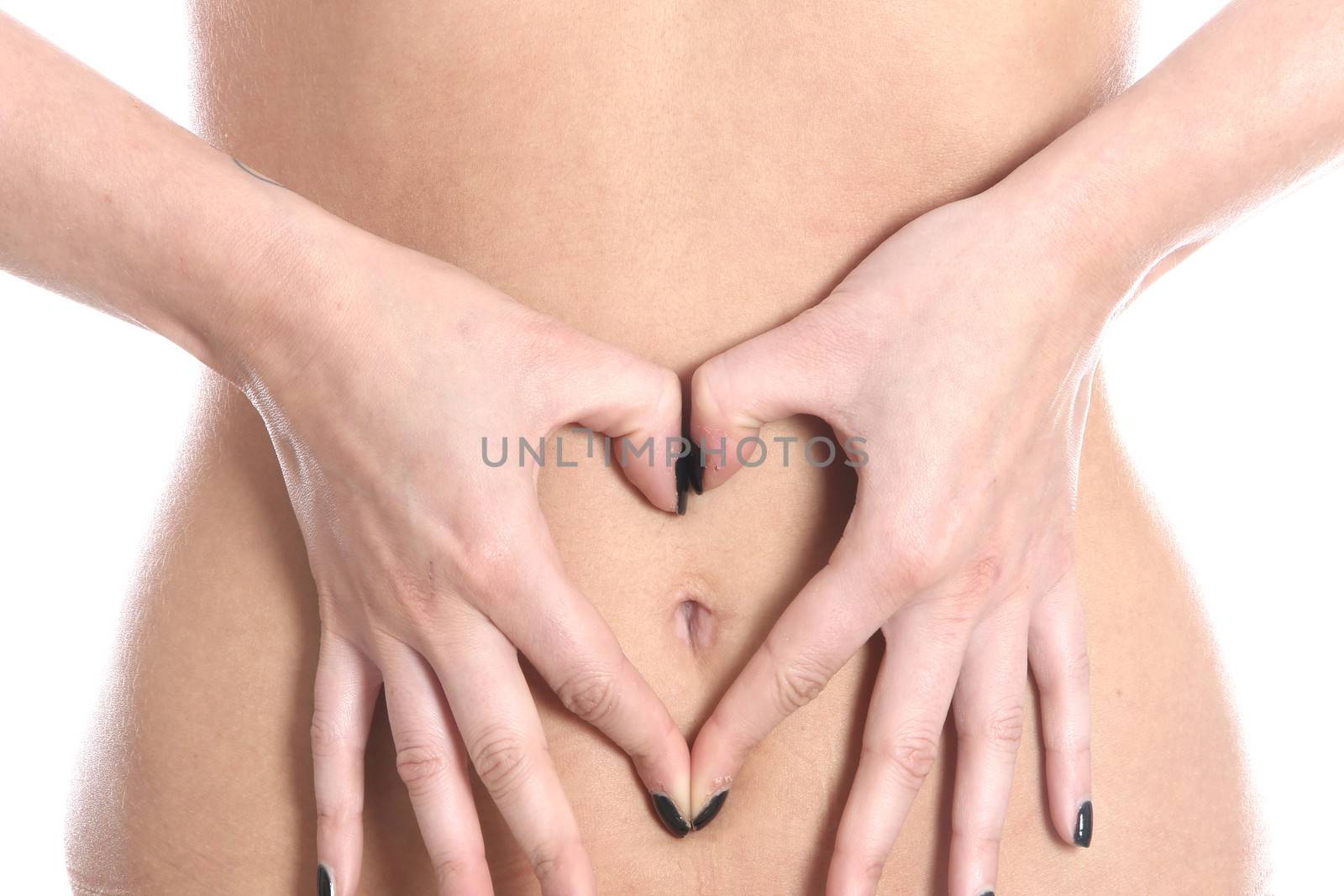 Model Released. Young Woman Making Heart on Tummy