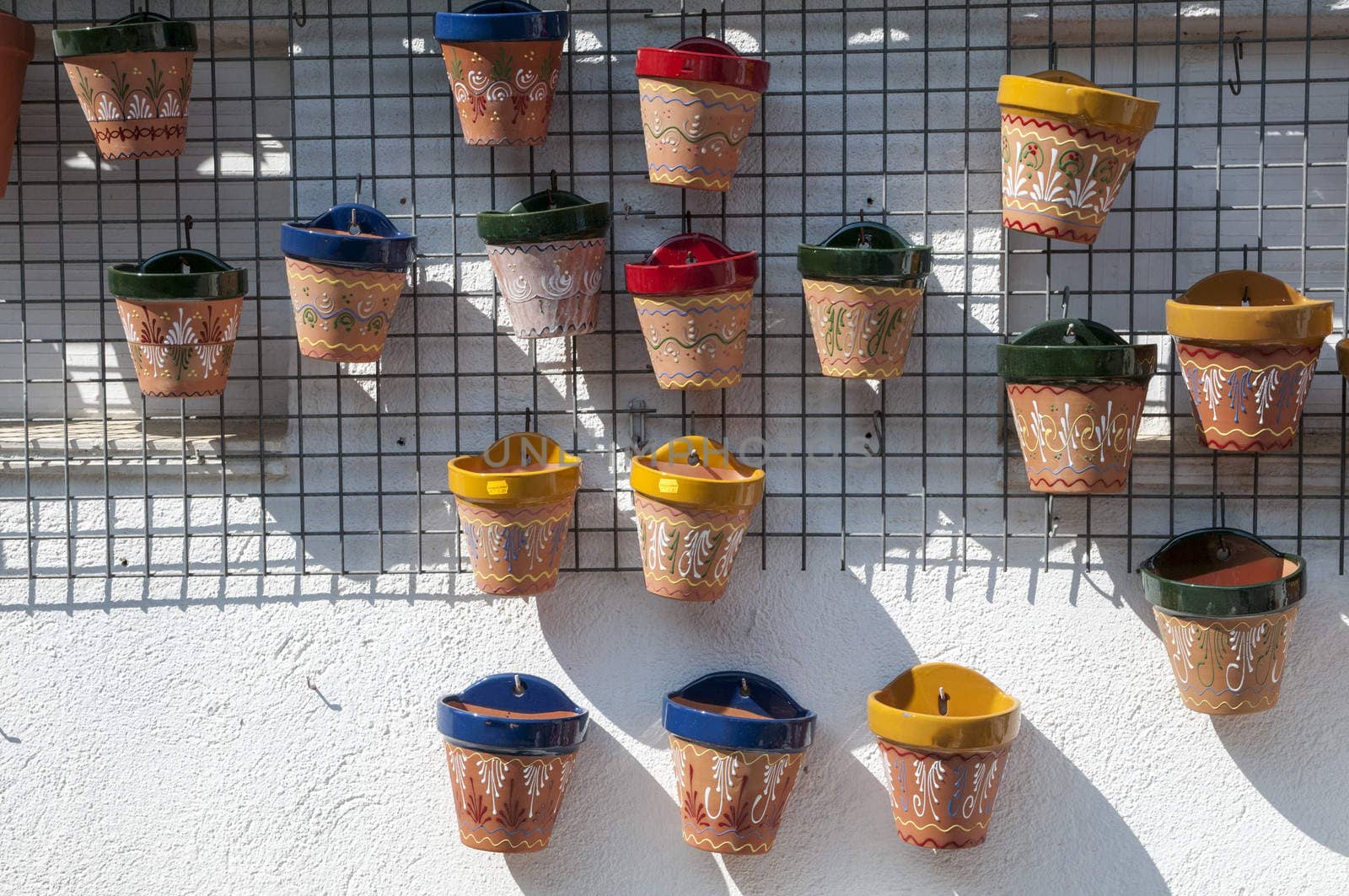 wall decorated with pots to plant