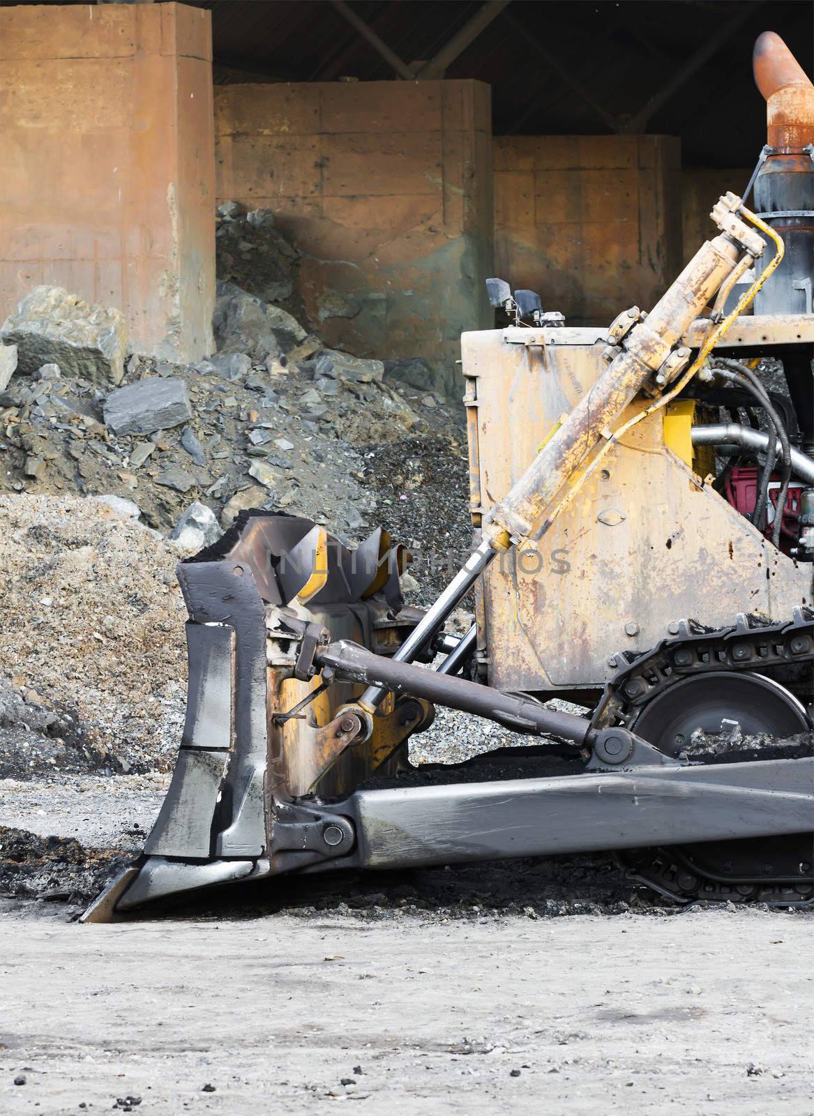Bulldozer machine doing earth moving work in construction site