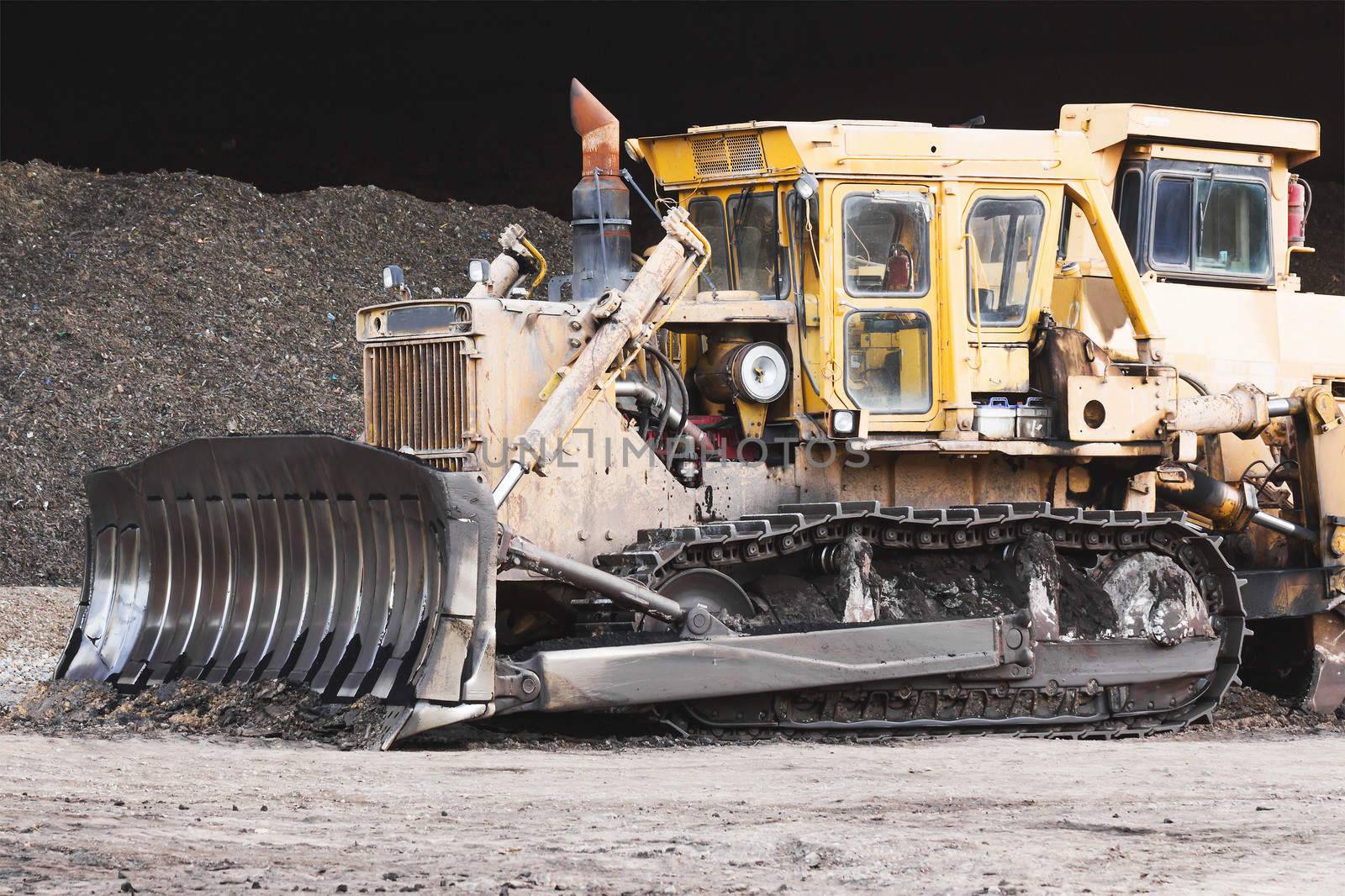 Bulldozer machine doing earth moving work in construction site