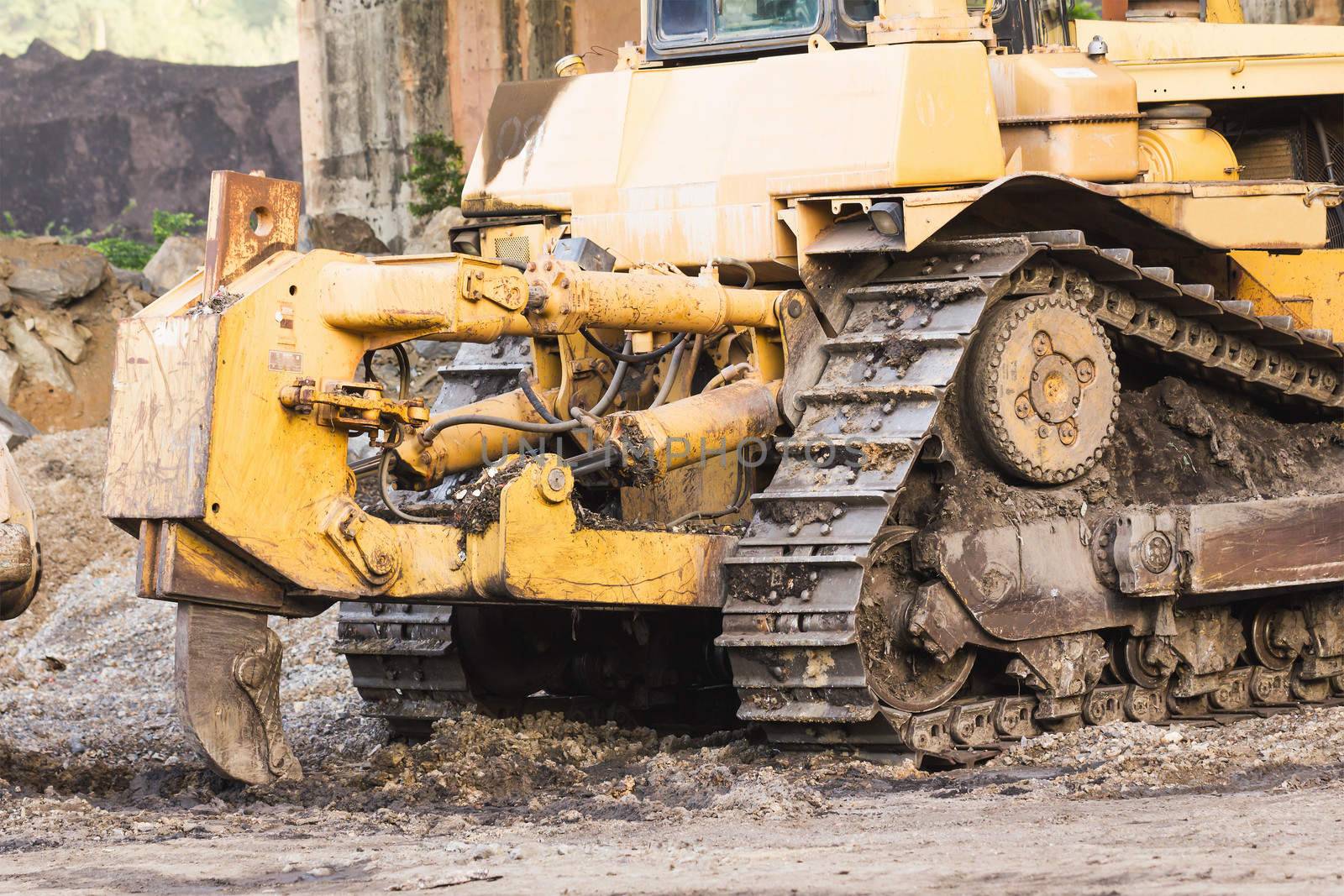 Bulldozer machine doing earth moving work in construction site