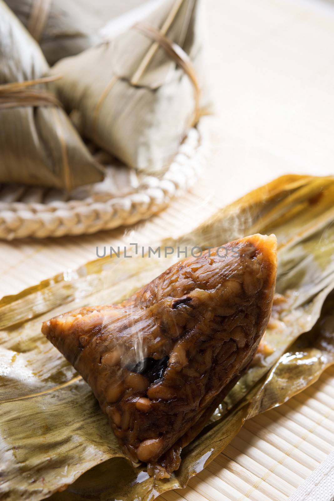 Hot steamed rice dumpling or zongzi. Traditional steamed sticky  glutinous rice dumplings. Chinese food dim sum. Asian cuisine.