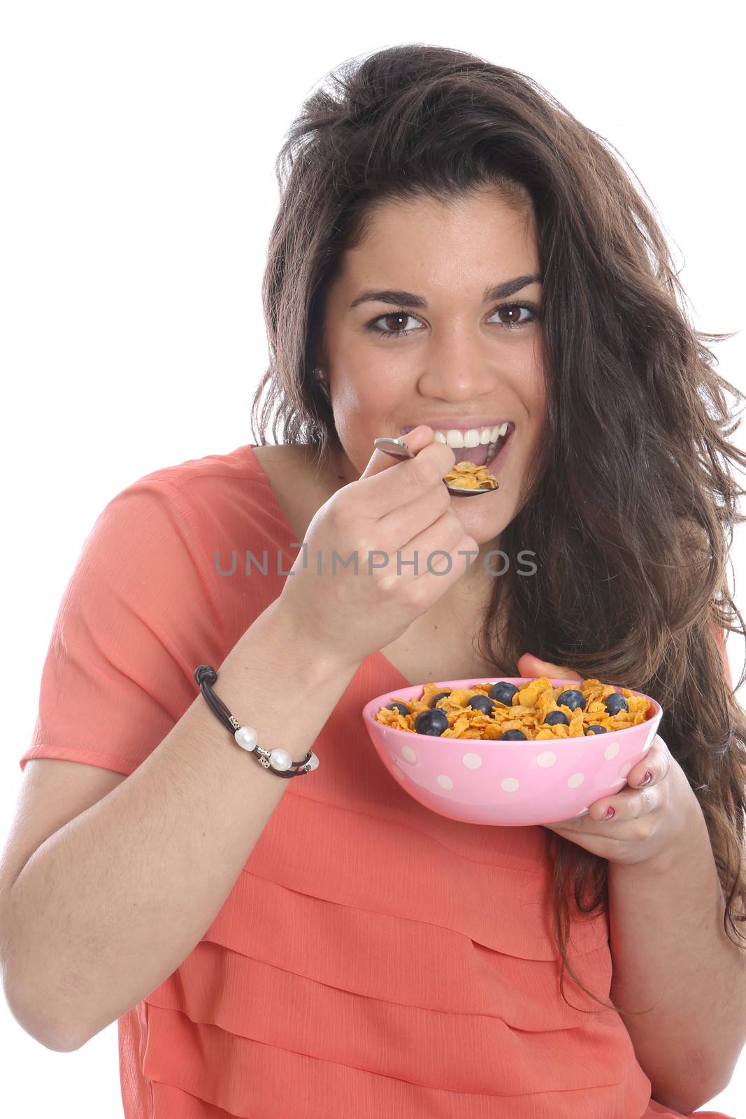 Model Released. Young Woman Eating Breakfast Cereal