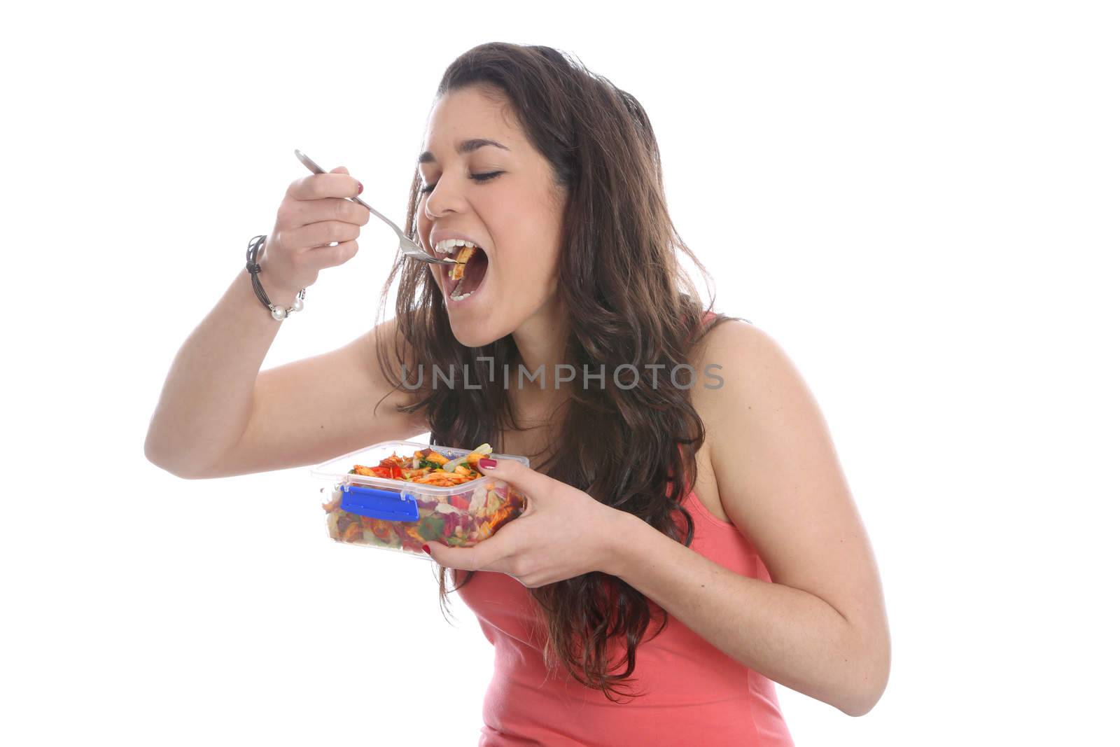 Model Released. Young Woman Eating Pasta Salad