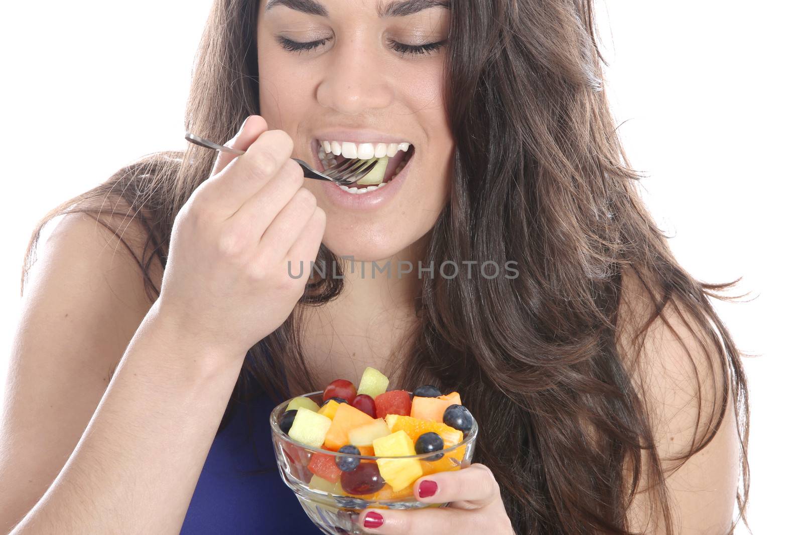 Model Released. Young Woman Eating Fresh Fruit Salad