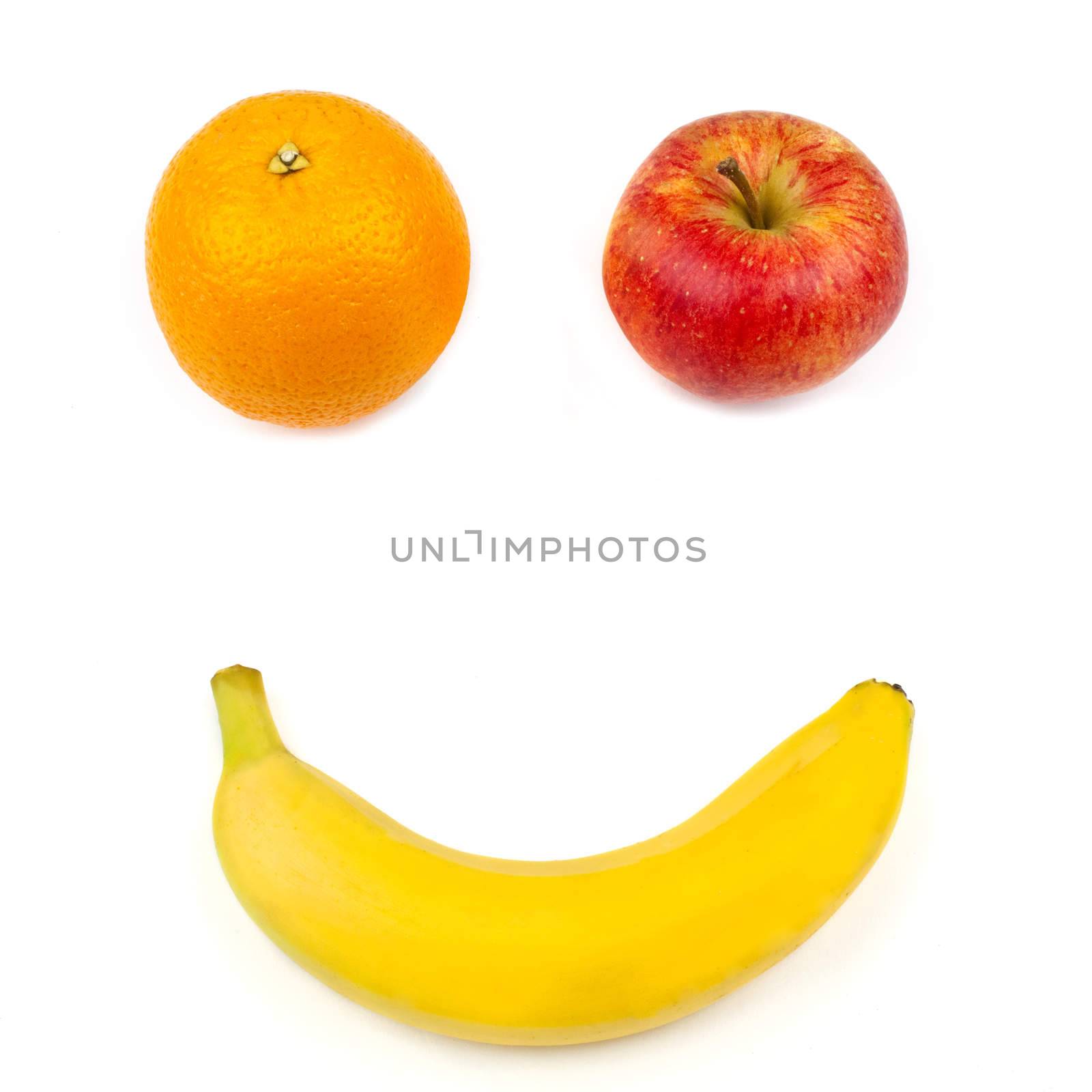 Three different pieces of fruit making up a smiling face over a white background.