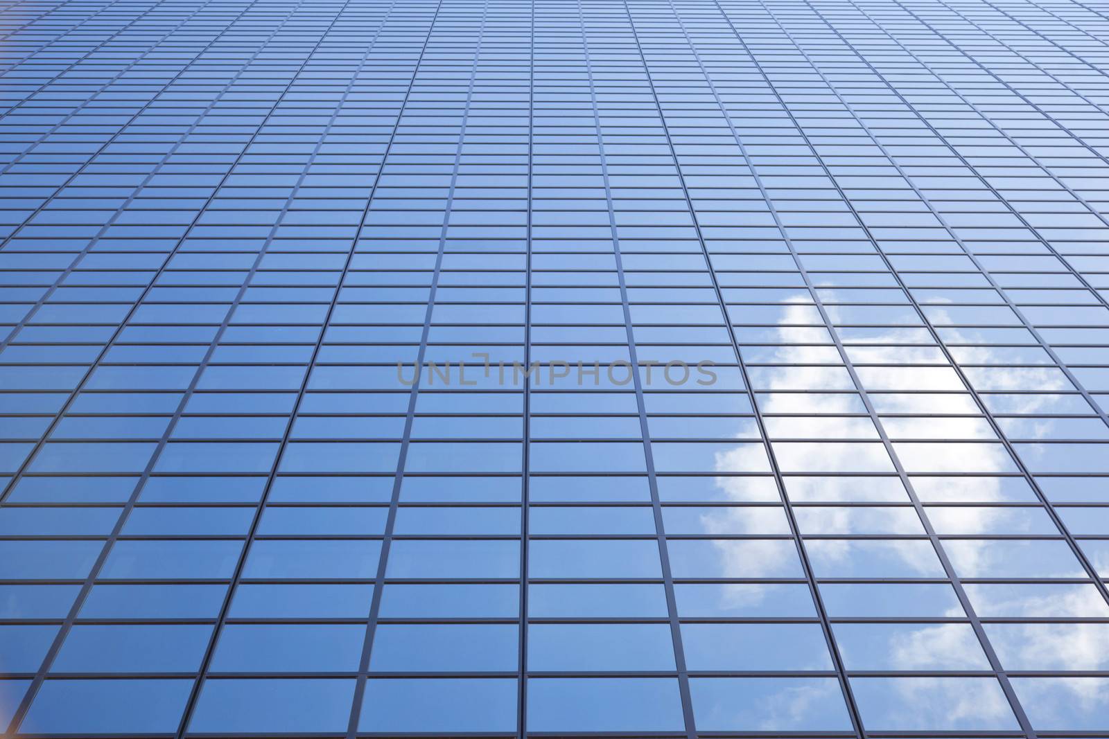 sky and cloud reflected in facade of office building Delftse Poort in Rotterdam