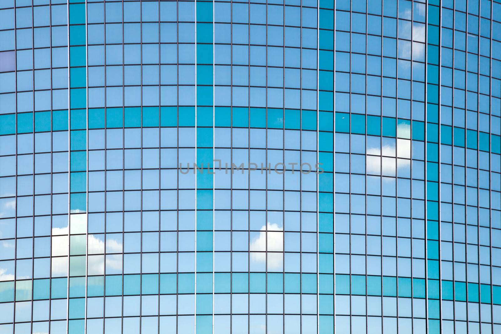 curved facade with reflections of sky and clouds in trade building in Rotterdam