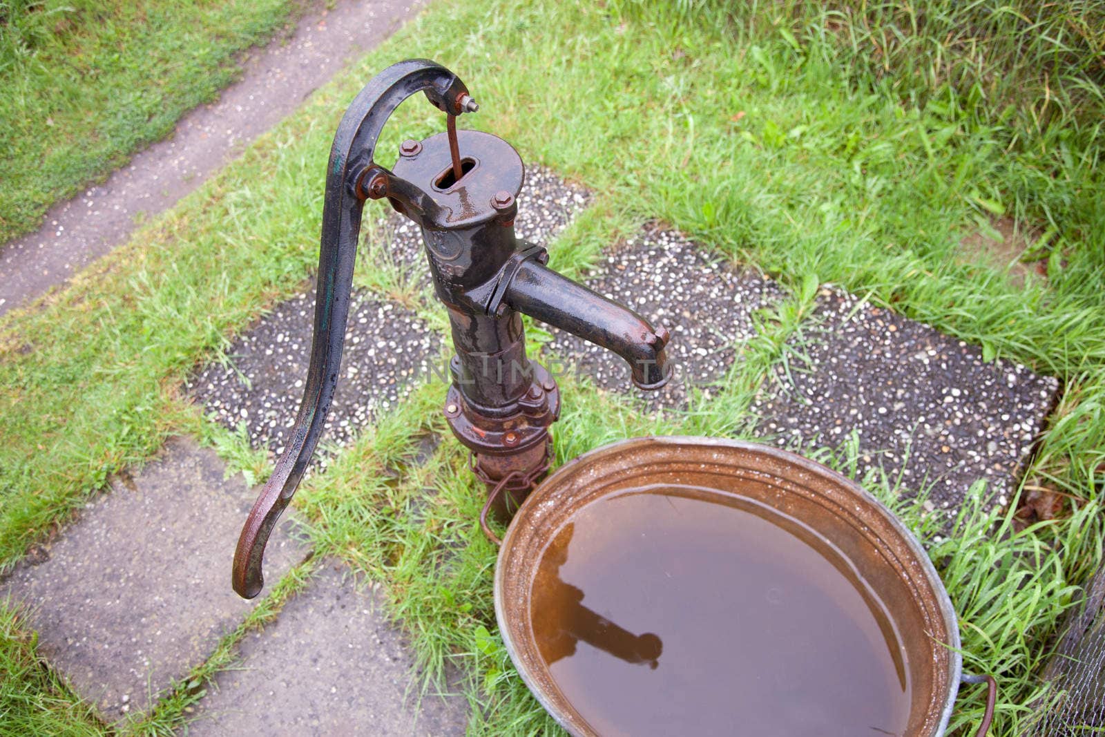 old wet cast iron water pump in garden