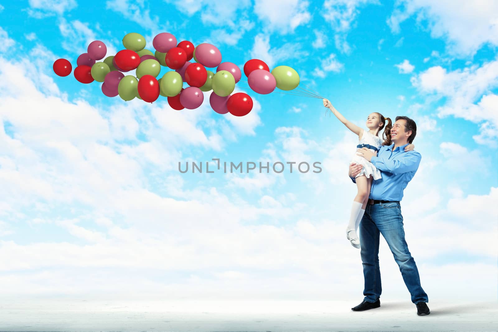 Image of happy father holding on hands daughter and balloons
