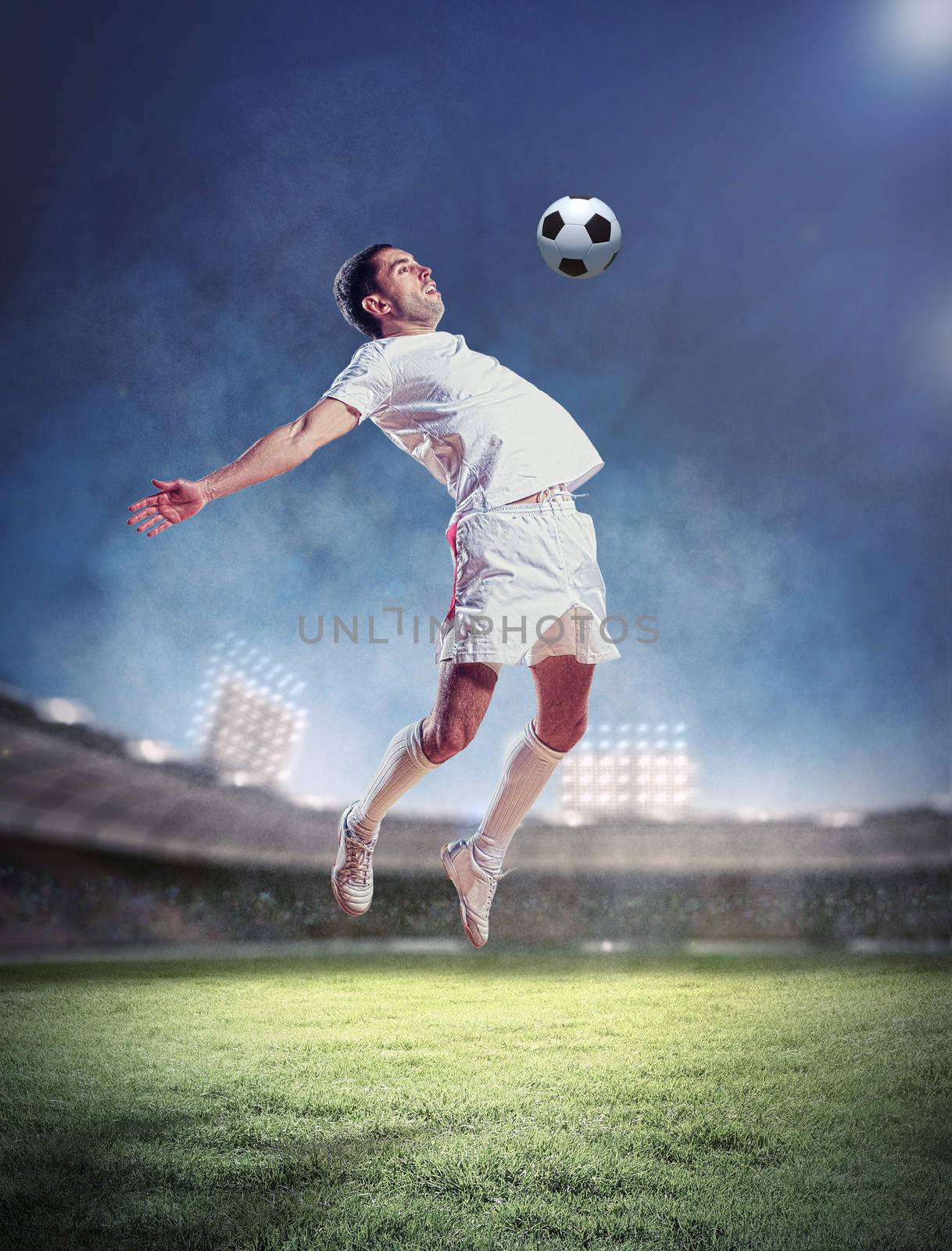 football player in white shirt striking the ball at the stadium