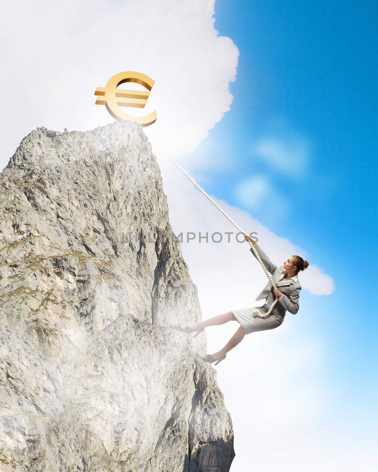 businesswoman climbing mountain with euro on top