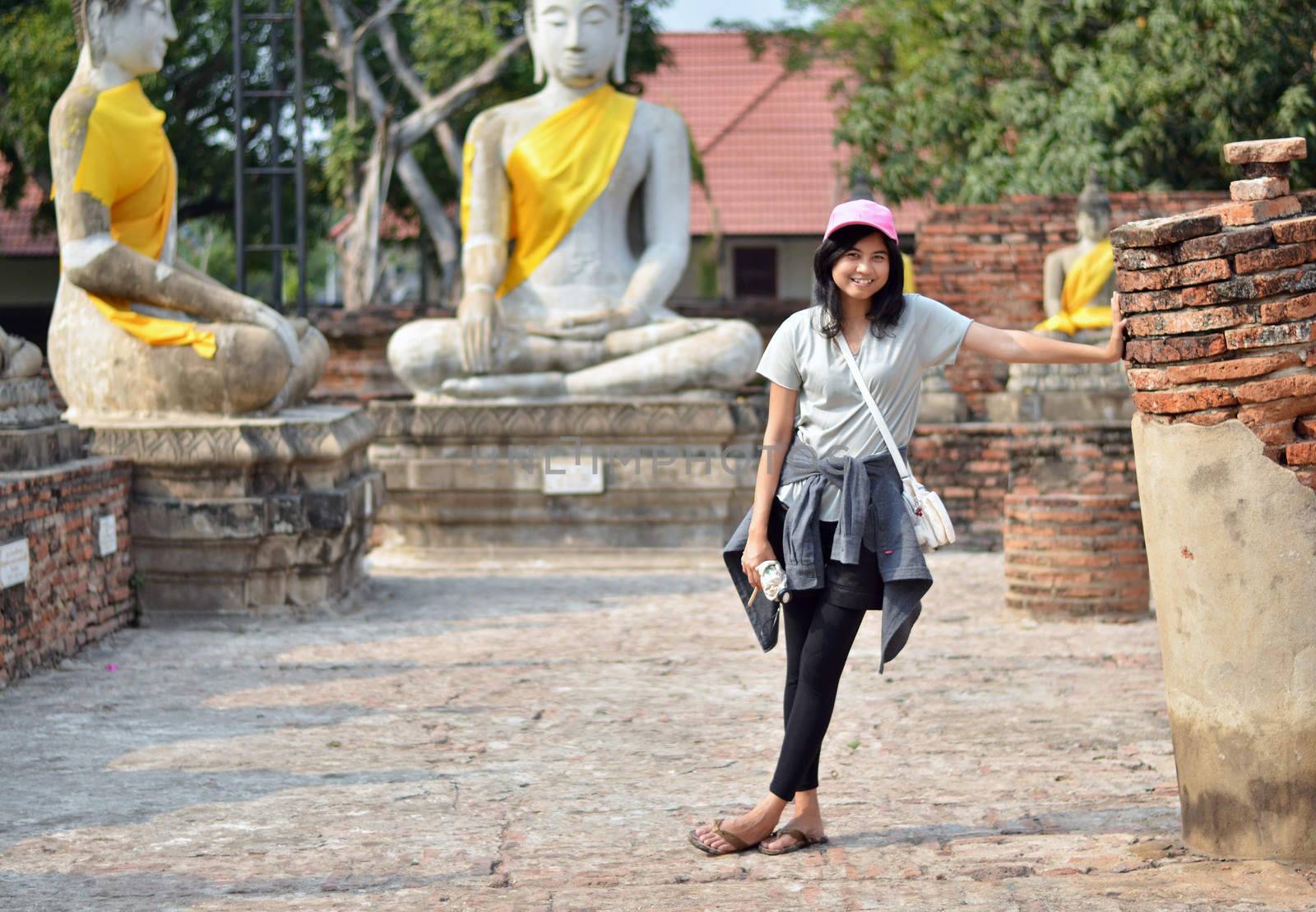 Beautiful asian woman and buddha at Wat Yai Chai Mongkol Temple. Ayutthaya - Thailand