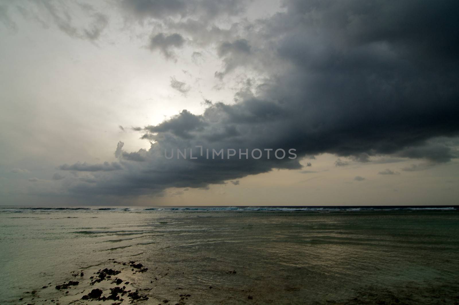 Beginning of Cloudy Sunrise over Ocean Water's Edge outdoors