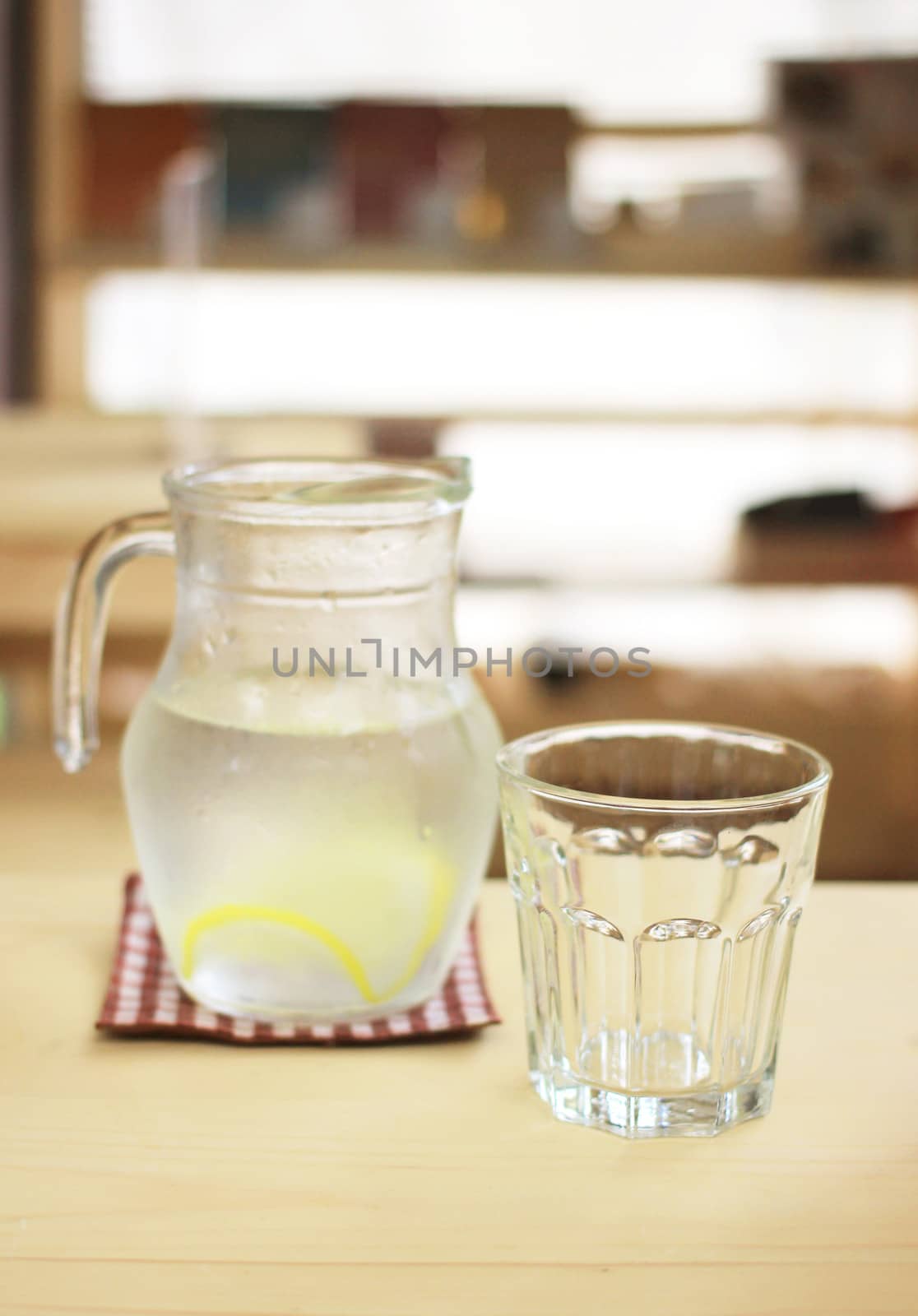 Jar of lemonade with empty glass for summer
