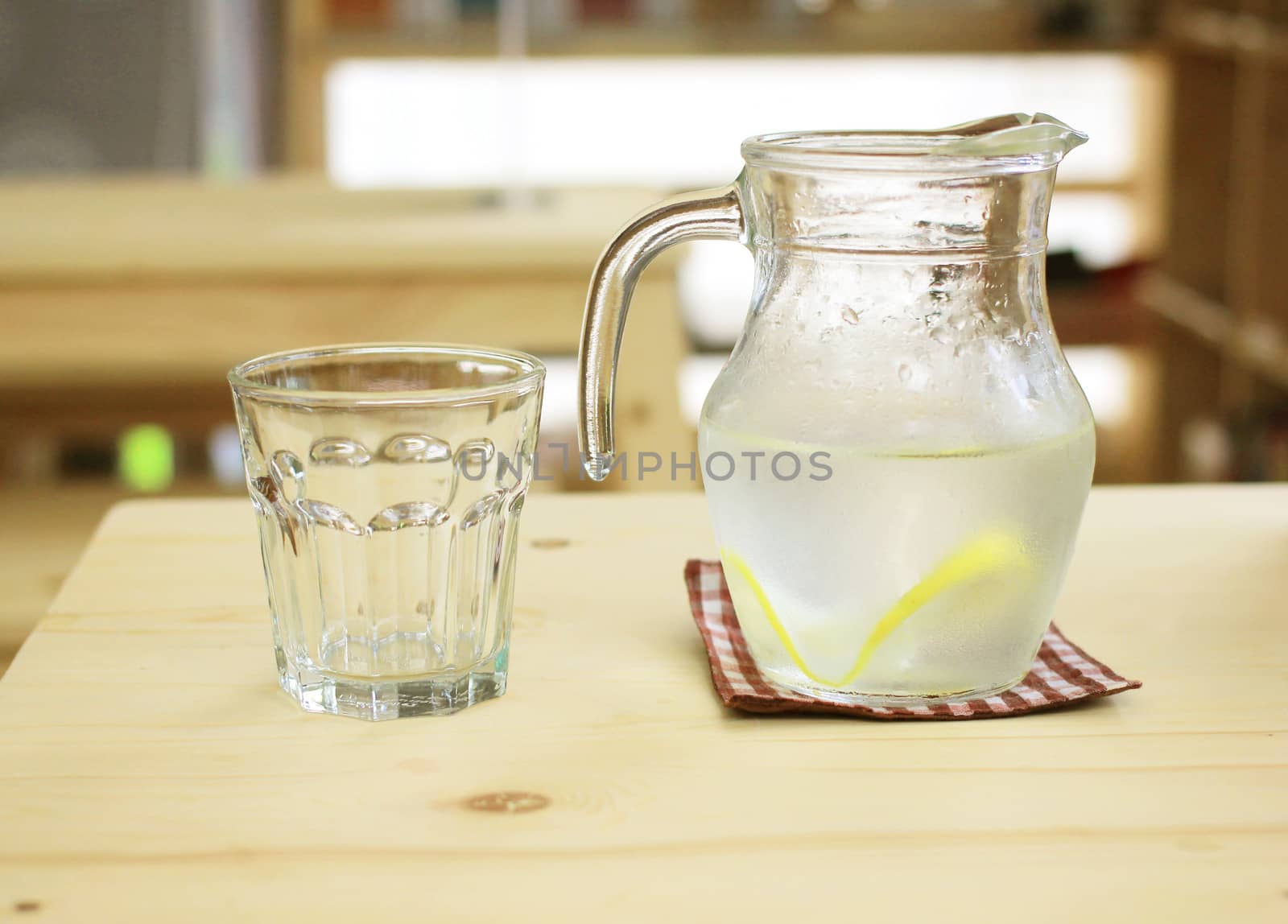 Jar of lemonade with empty glass for summer