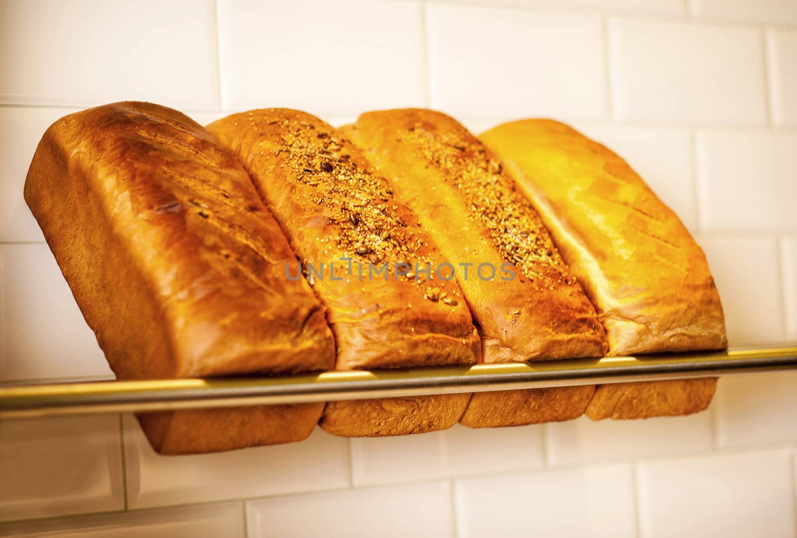 Freshly kneaded grain and white breads for sale by stockyimages