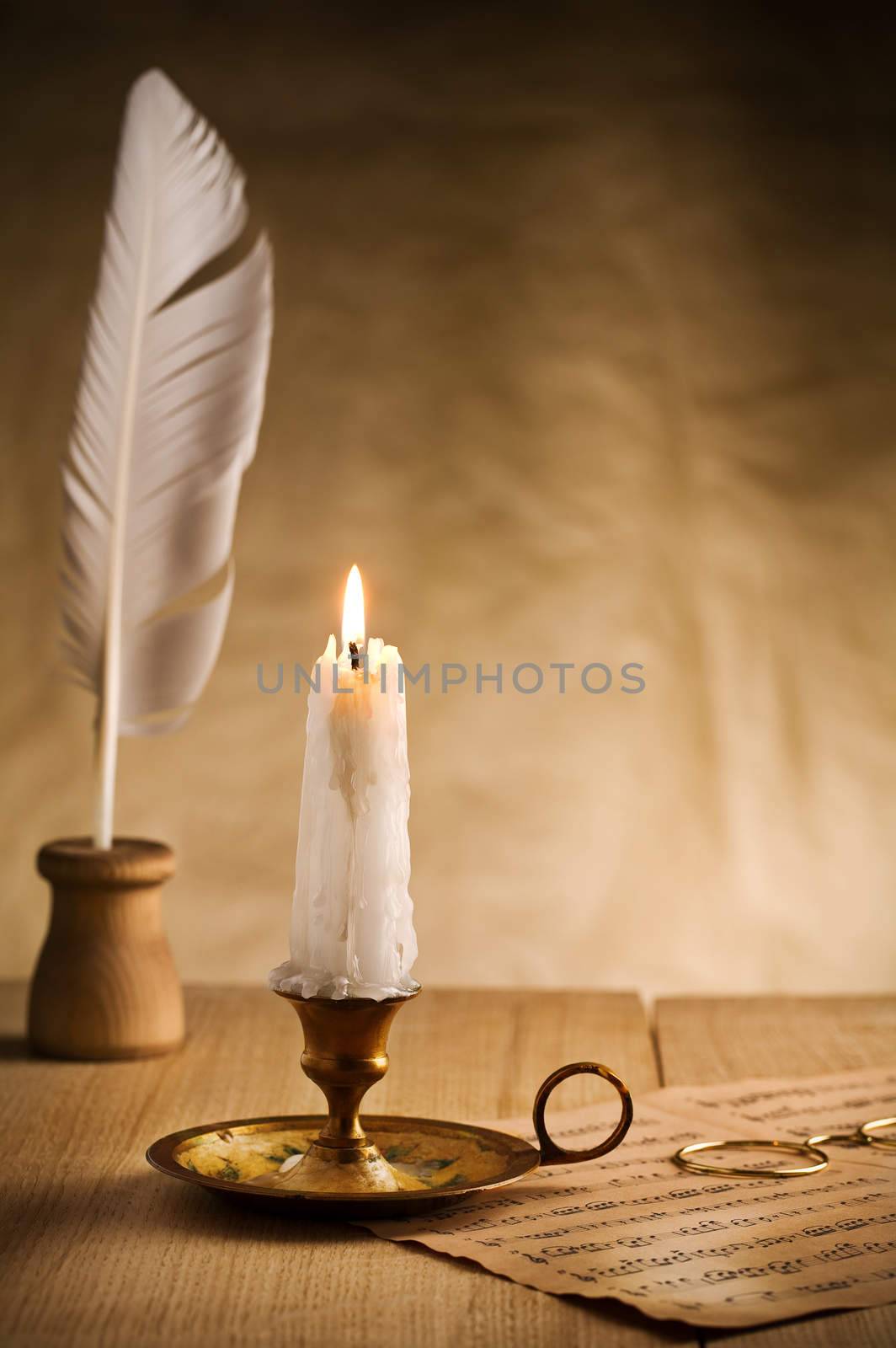 burning candle in vintage candlestick by mihalec