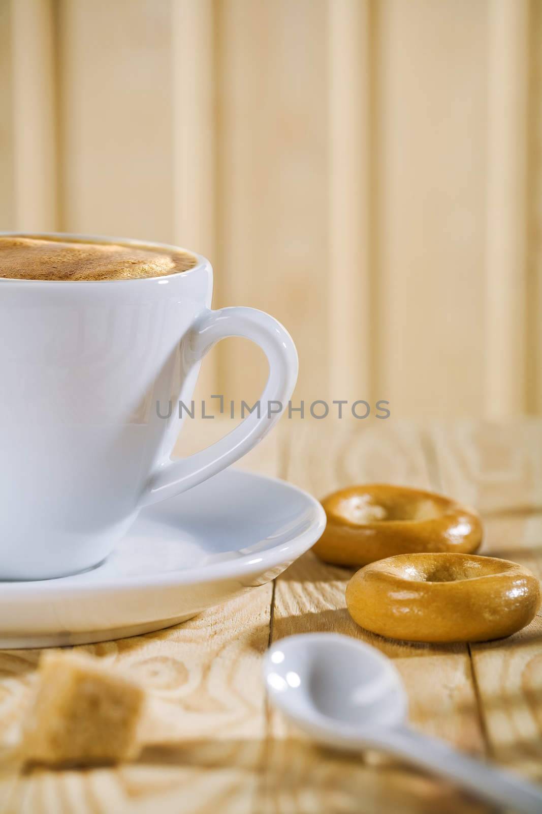composition of the white coffee cup with spoon and bread tor, bar of sugar